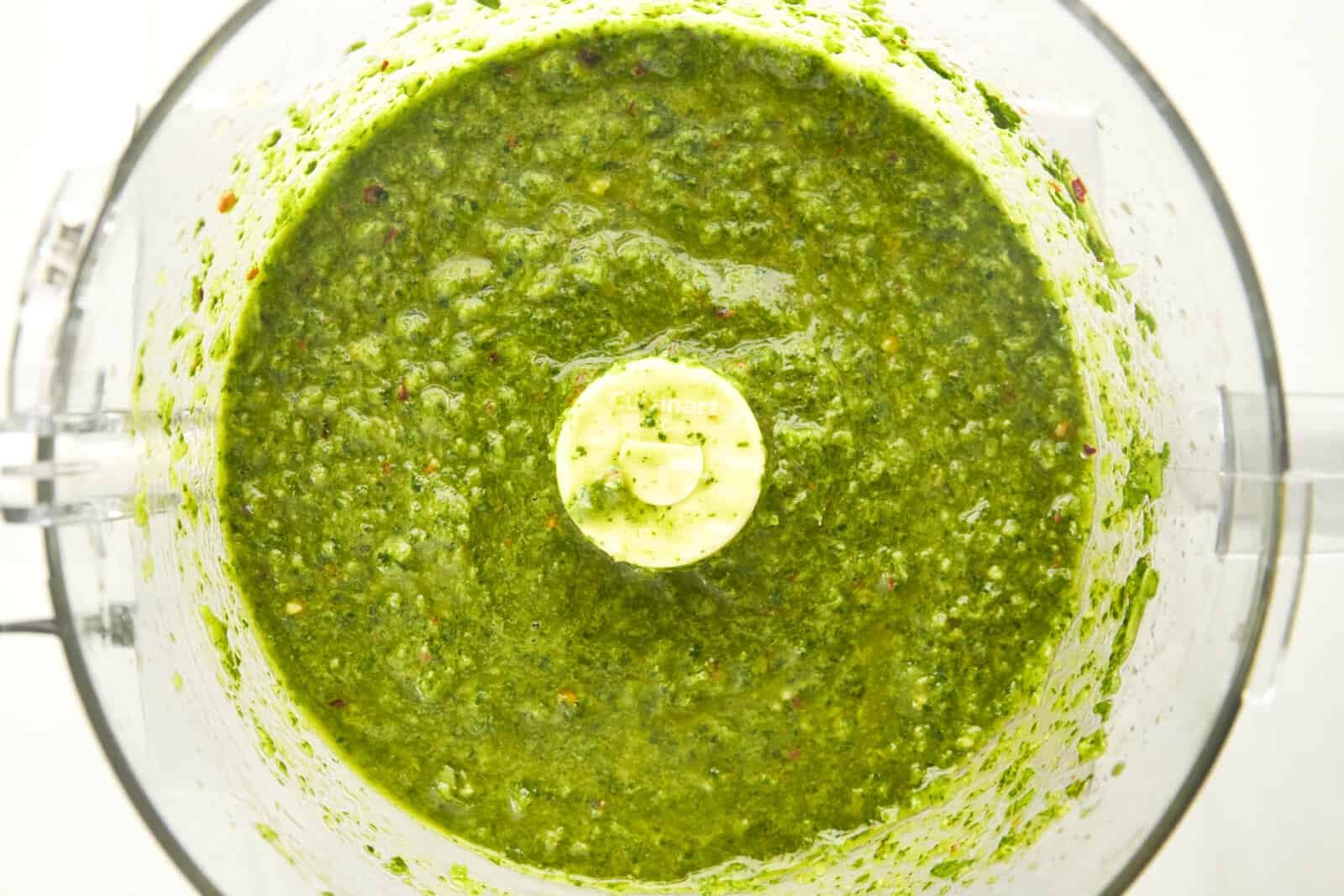 Overhead image of zhoug sauce in a food processor.