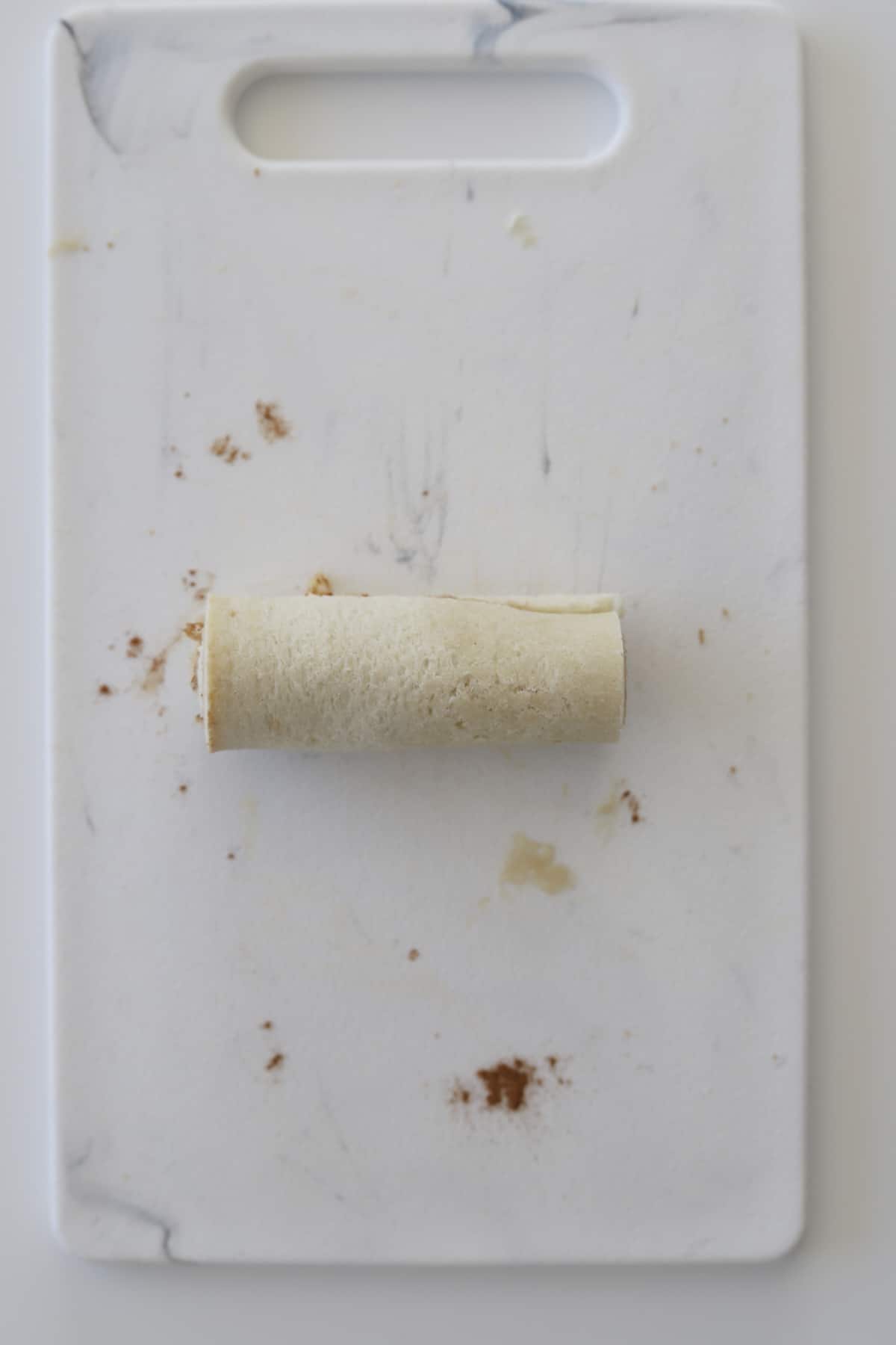 an uncooked cinnamon roll french toast roll up