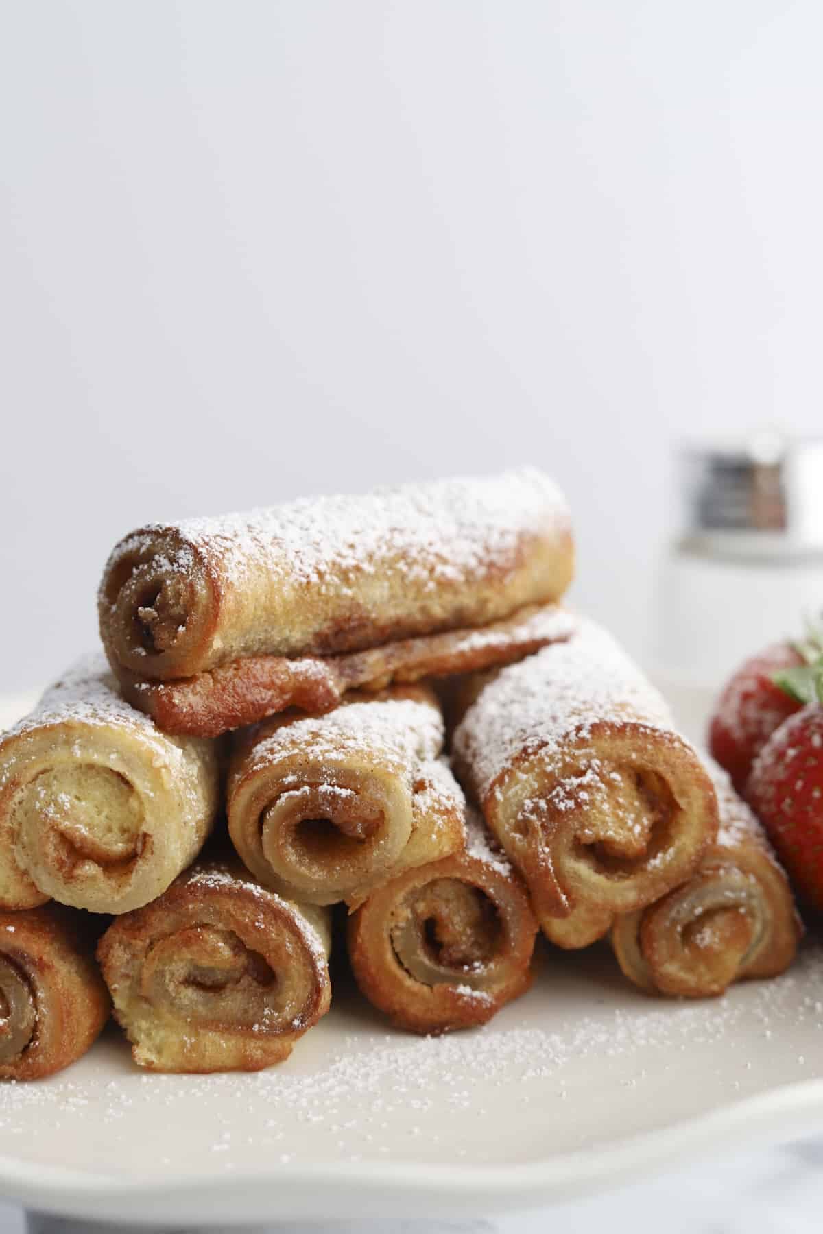 plate of cinnamon roll french toast roll ups