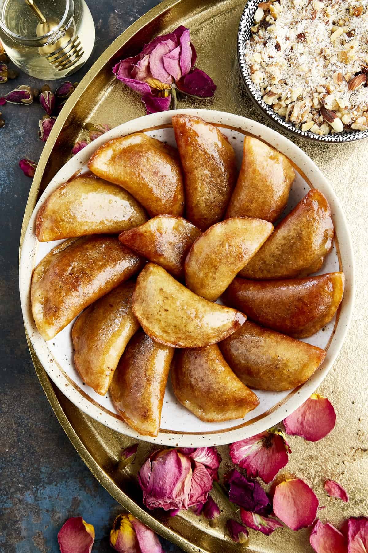 Overhead image of a bowl of qatayef with nuts.