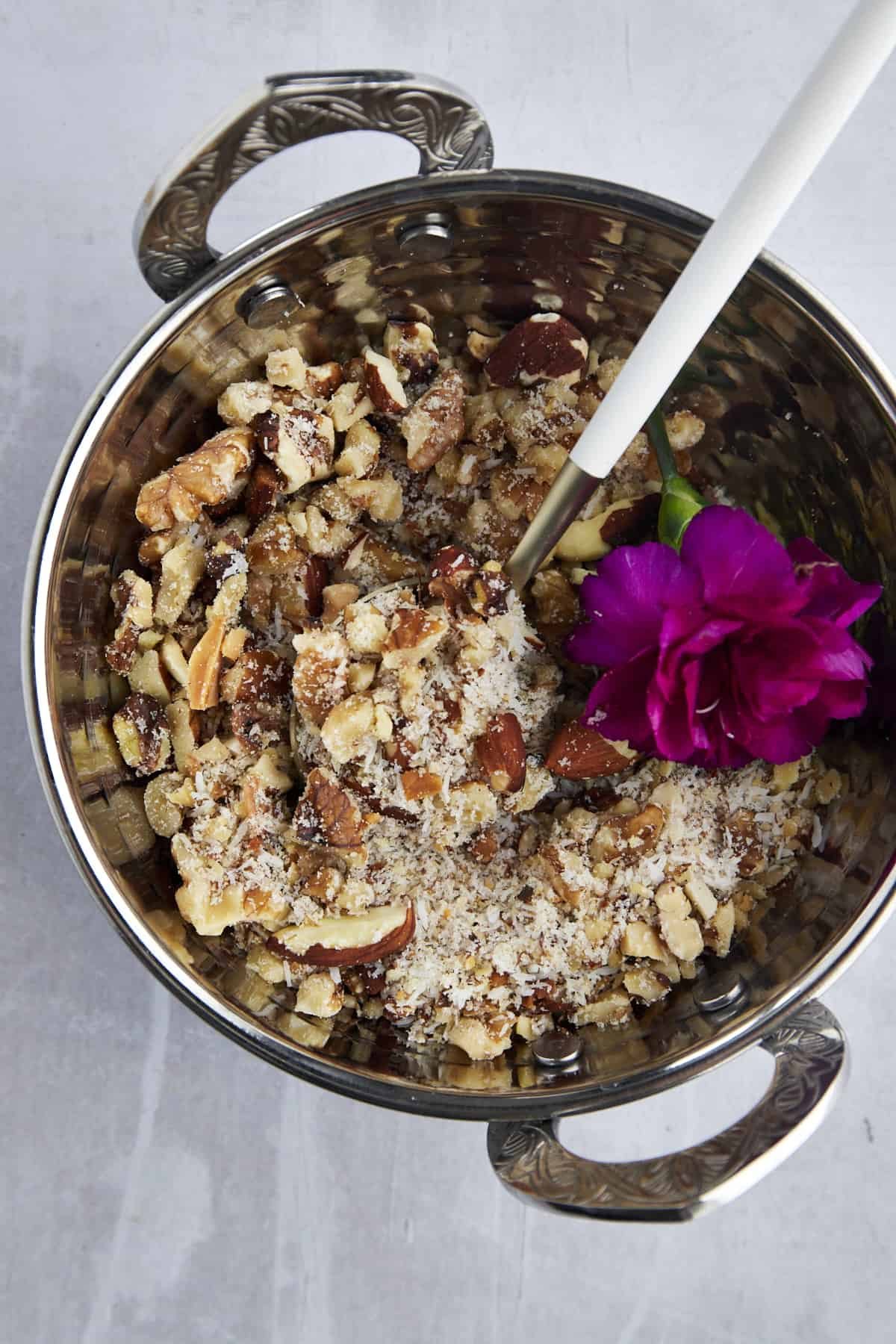 chopped nuts in a pot with sugar and cinnamon