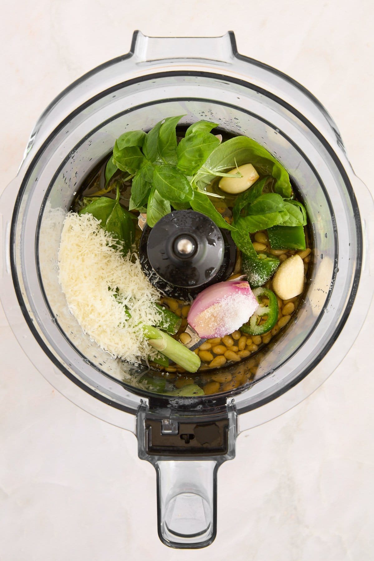 Green goddess dressing ingredients in a food processor.