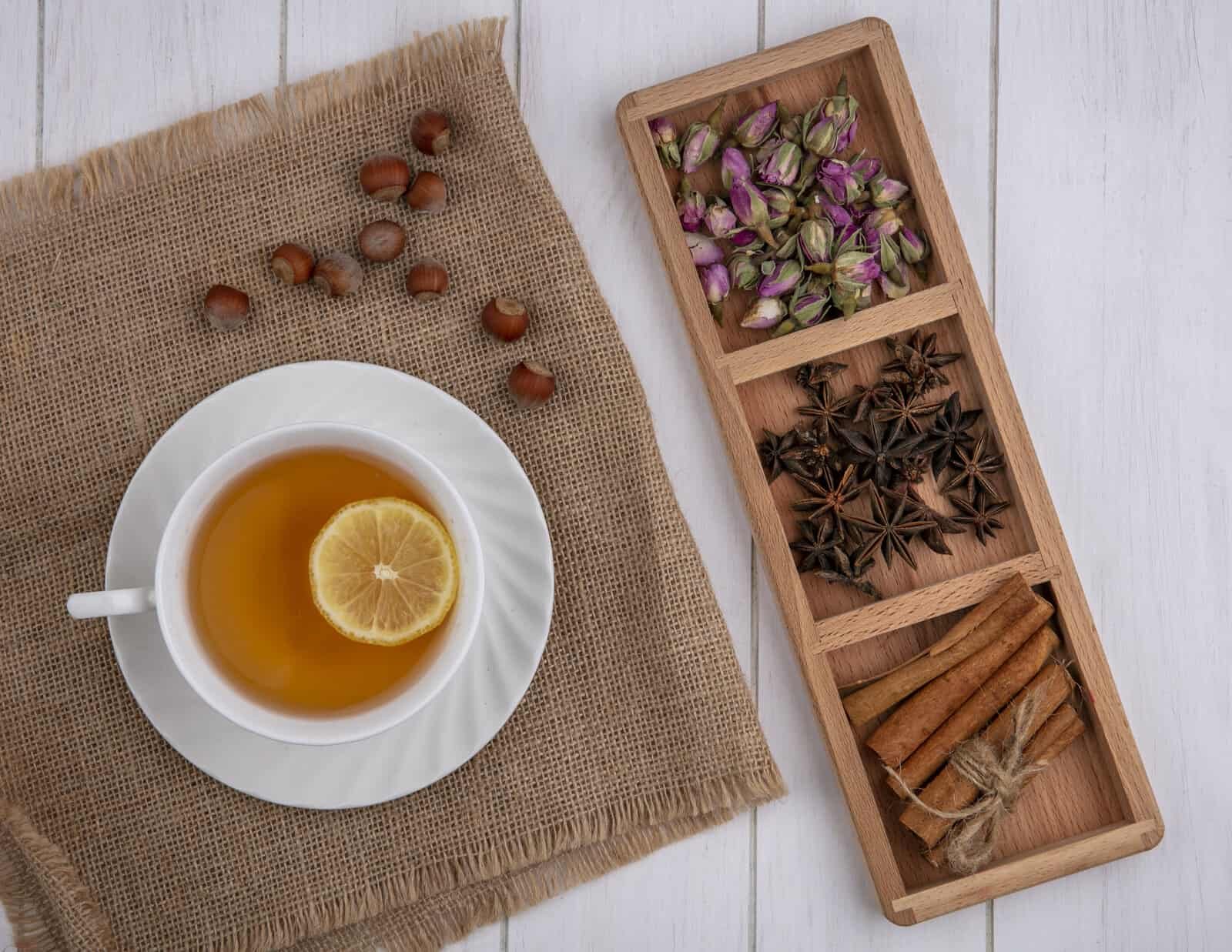 cup of tea next to container with spices.