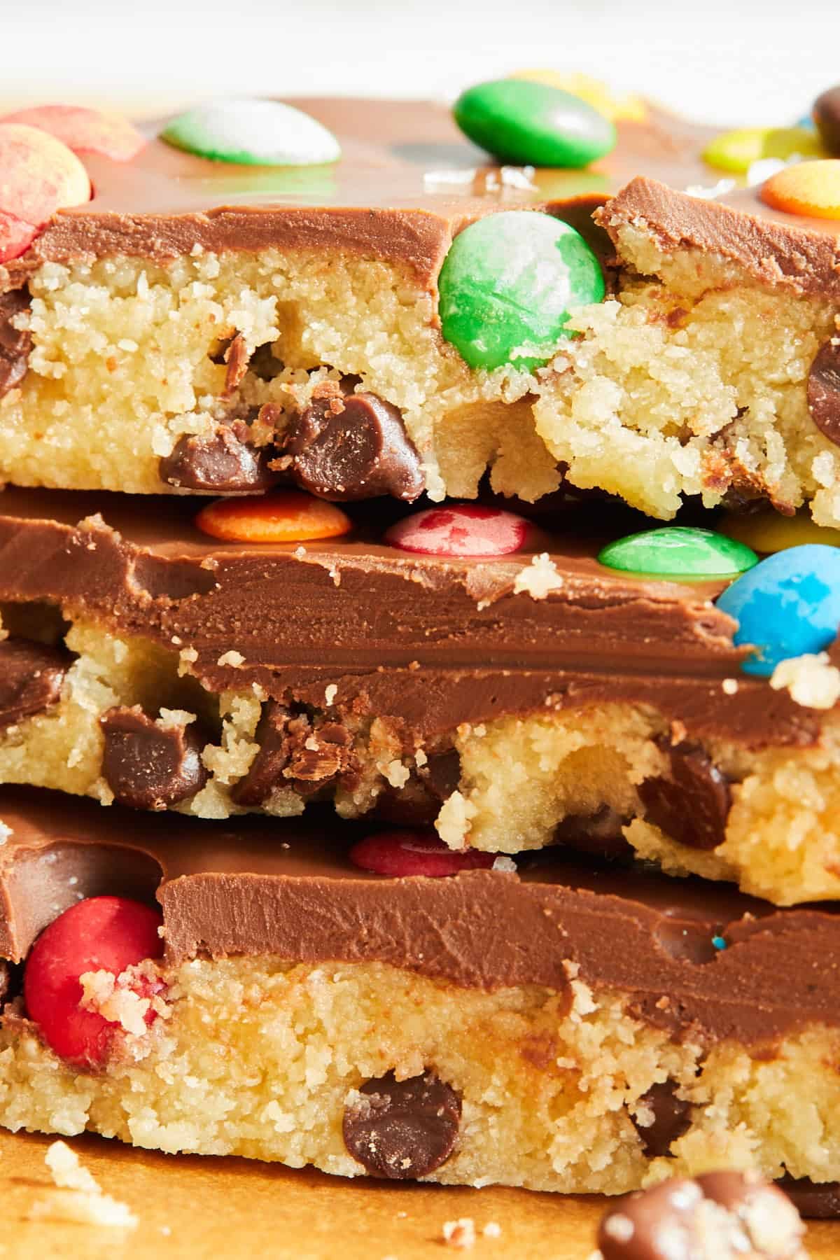 Pieces of chocolate chip cookie dough bark stacked on top of each other.