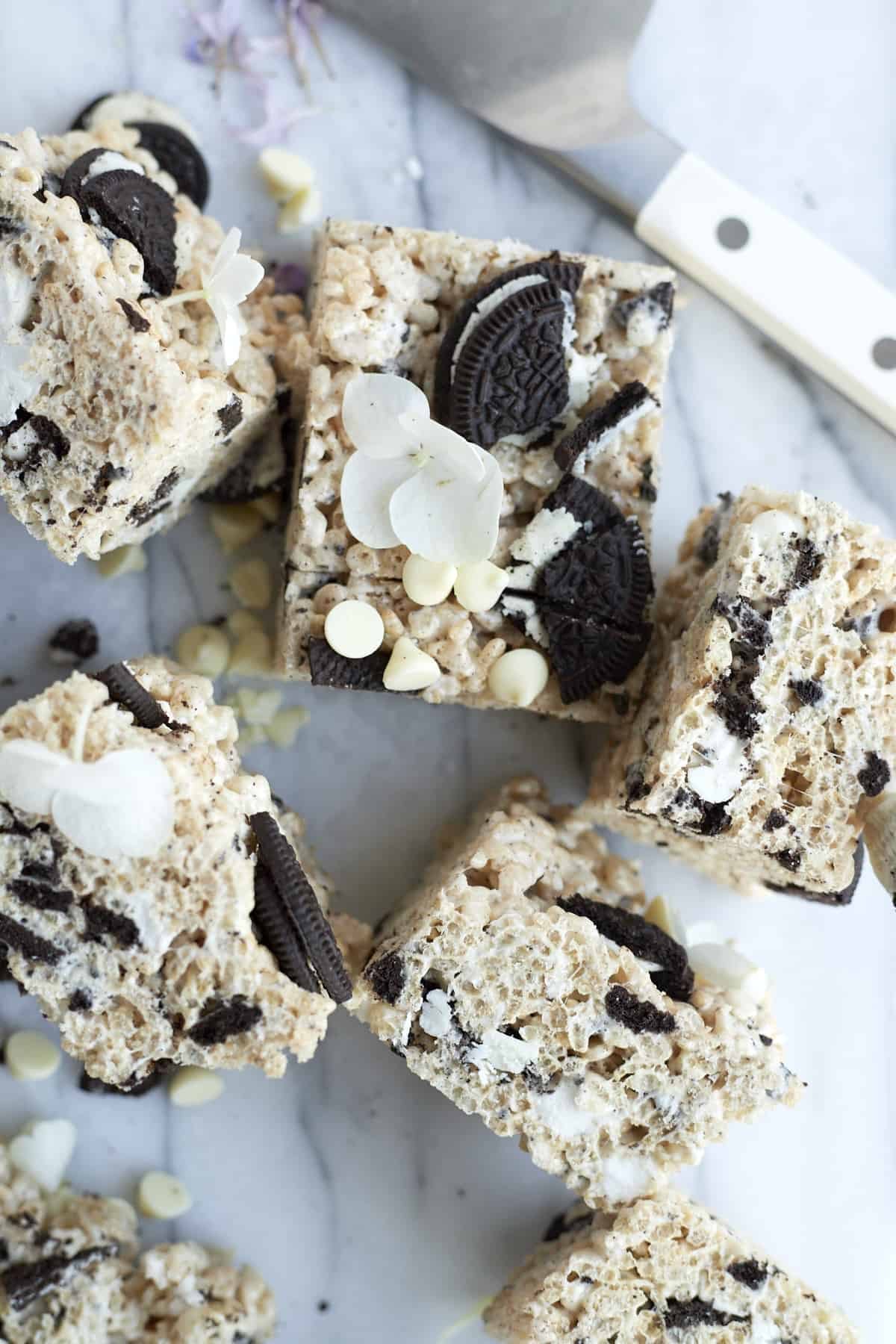 6 Oreo Rice Krispie Treats topped with white chocolate chips and Oreo chunks