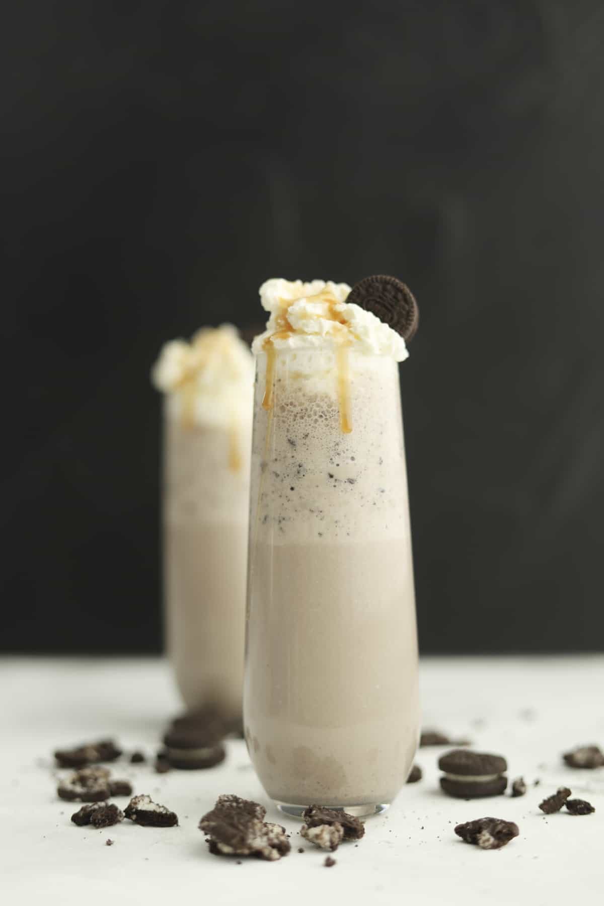 side view of oreo frappuccino with caramel dripping down the side and straw