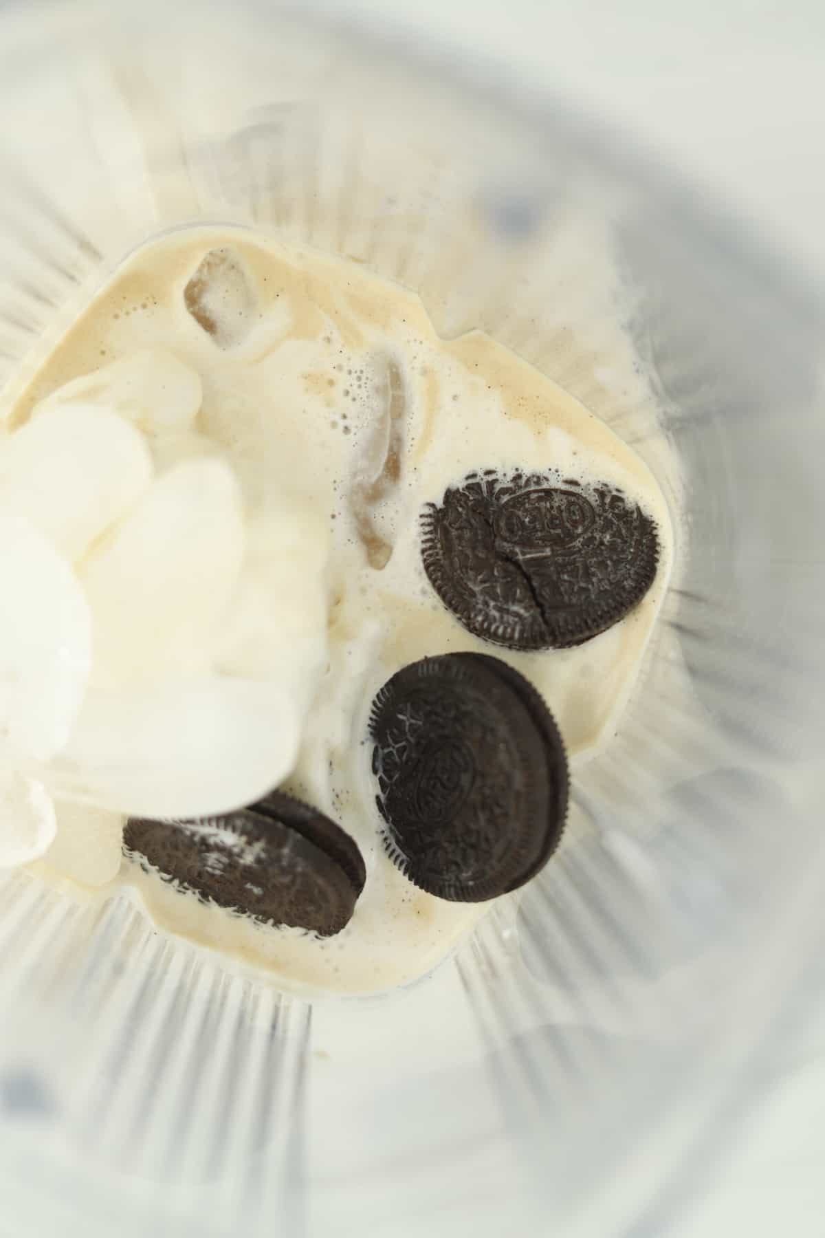 blender of milk, ice, ice cream, and oreos