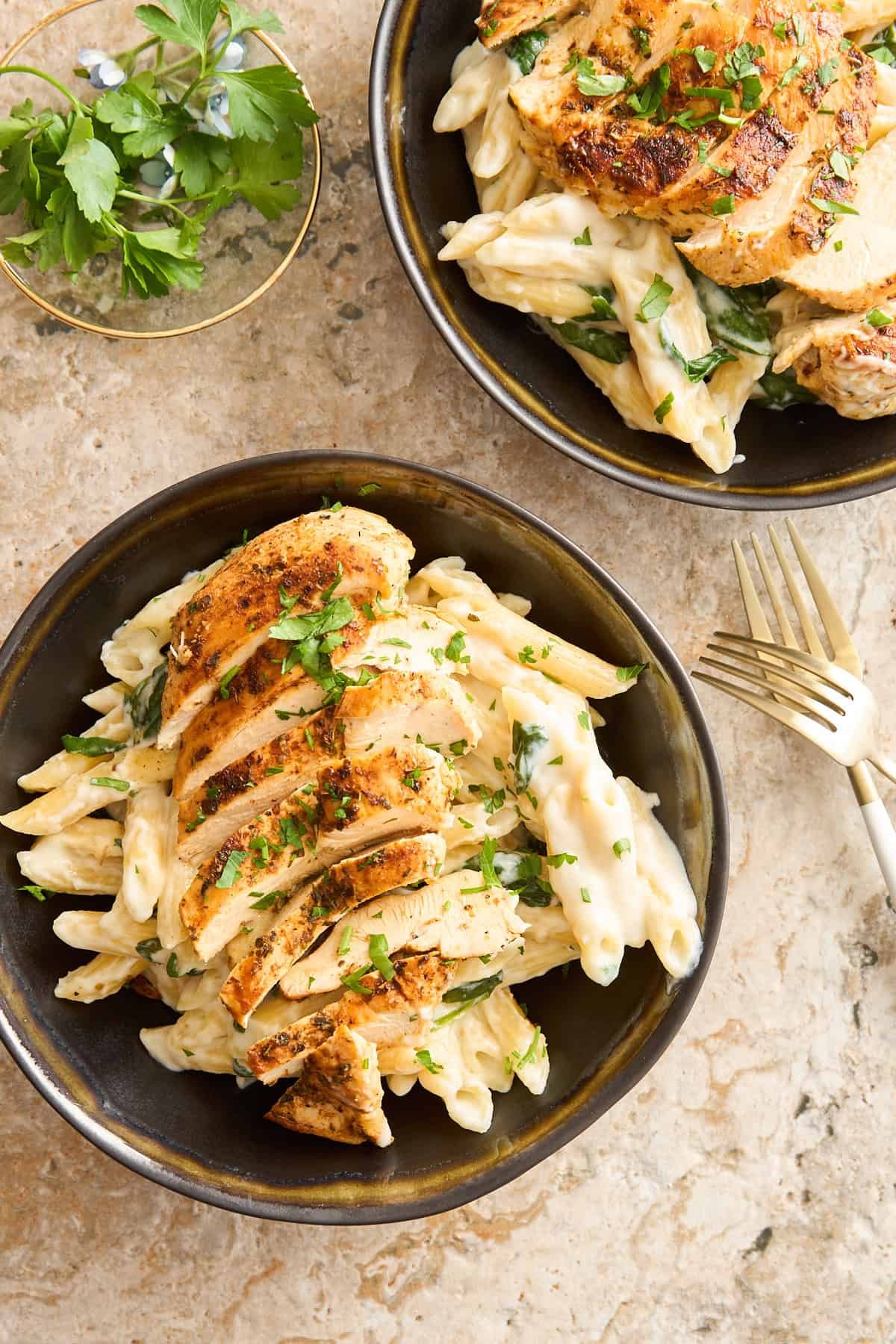 Two bowls of cottage cheese pasta with chicken.