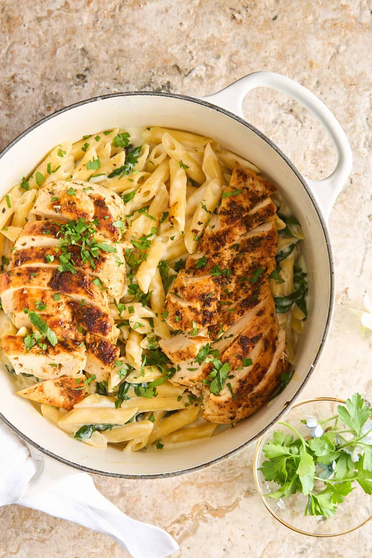 A pot of cottage cheese pasta topped with chicken.