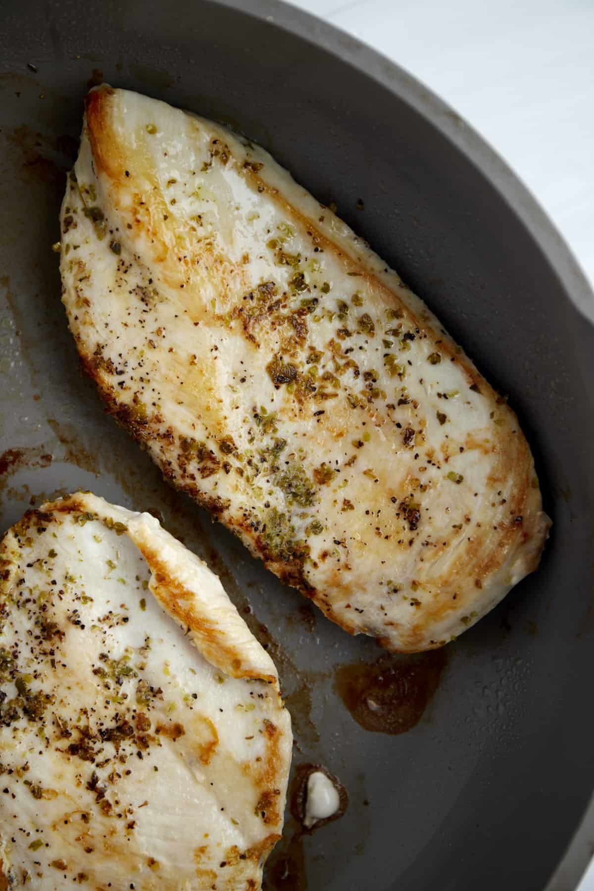 seasoned cooked chicken breasts in a skillet