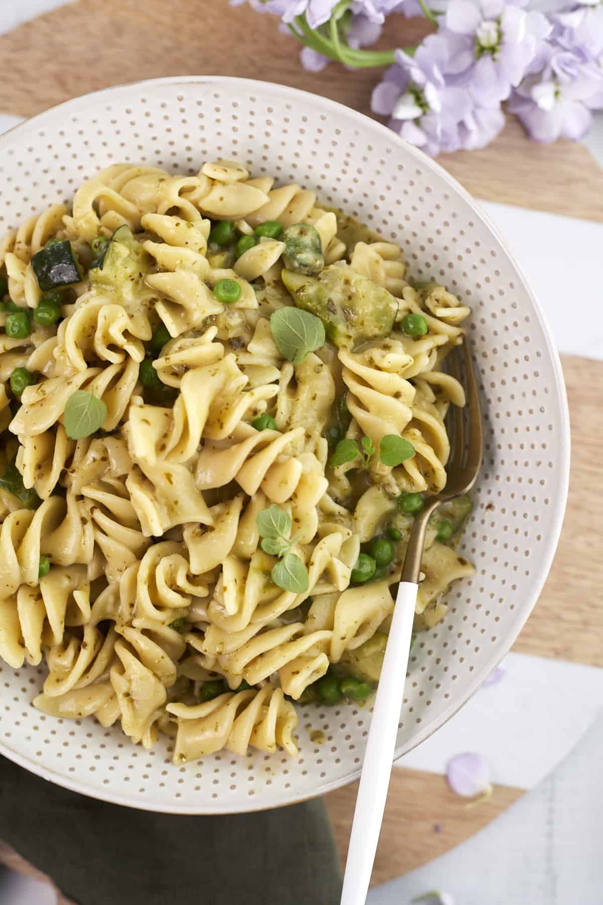 a bowl of silky pesto pasta with a fork sticking out