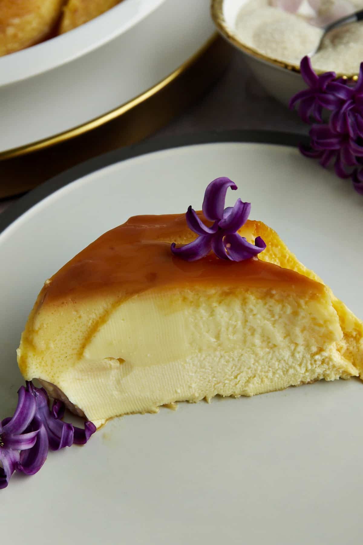 side view of a slice of creme caramel on a plate.
