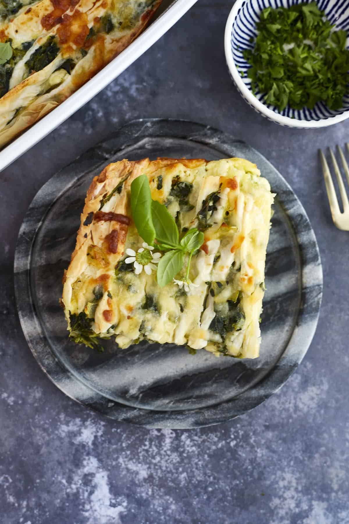 a slice of simple spanakopita recipe on a plate.