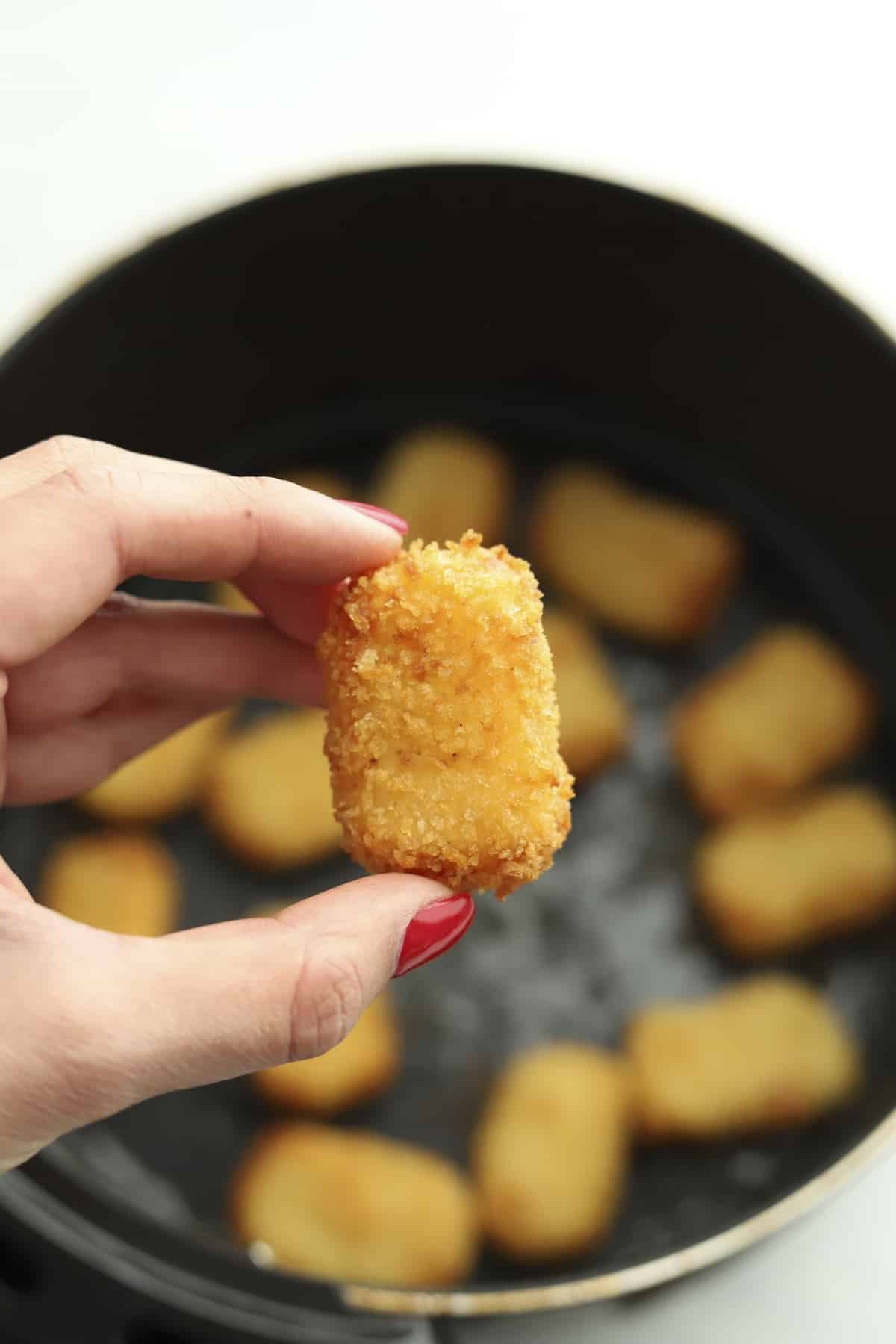 hand holding air fryer nugget