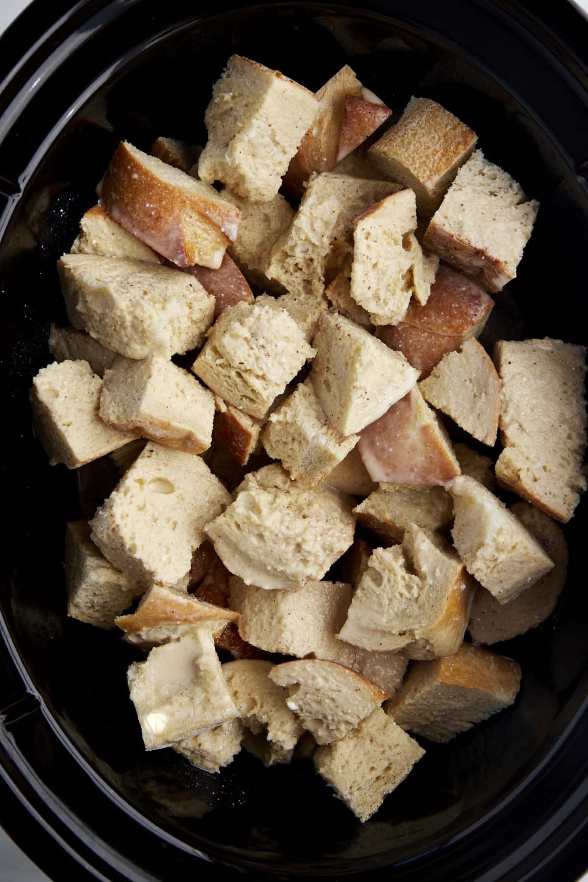 Cubed pieces of bread in a crockpot.