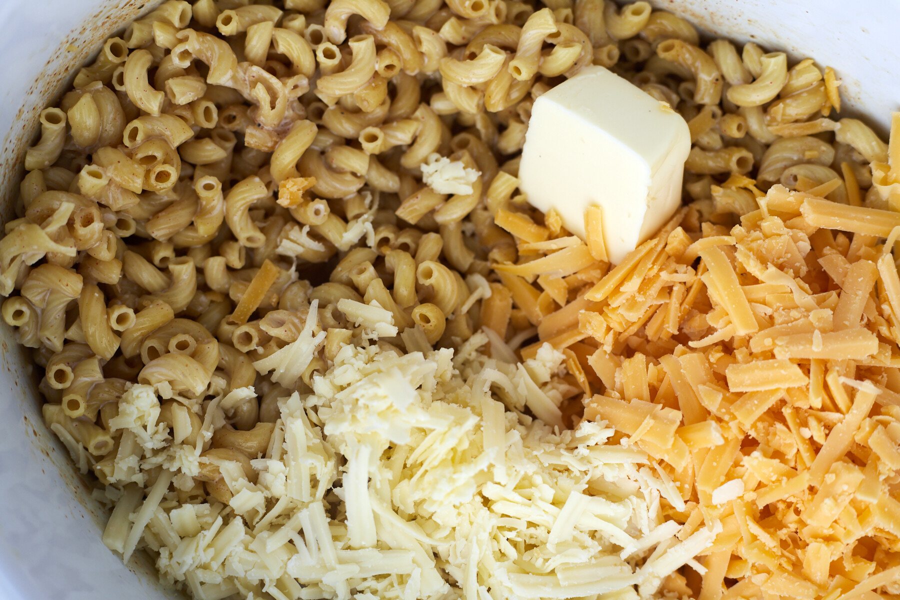 Ingredients for crockpot mac and cheese in the crockpot.