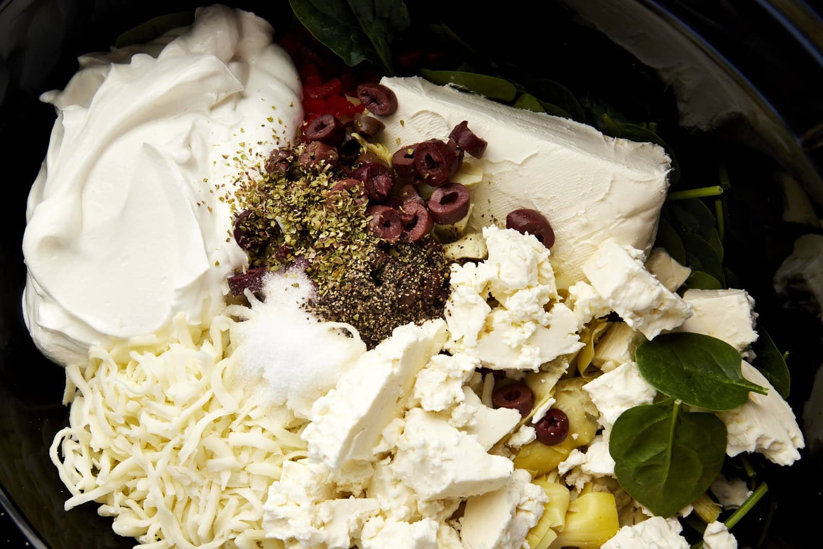Close up image of ingredients to make Mediterranean-inspired spinach and artichoke dip.