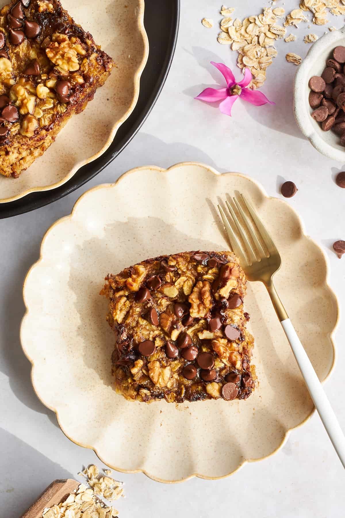 A slice of date oatmeal on a plate with a fork.