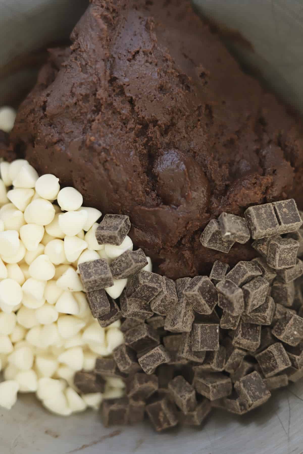 chocolate cookie dough, dark chocolate chunks, and white chocolate chips in a bowl