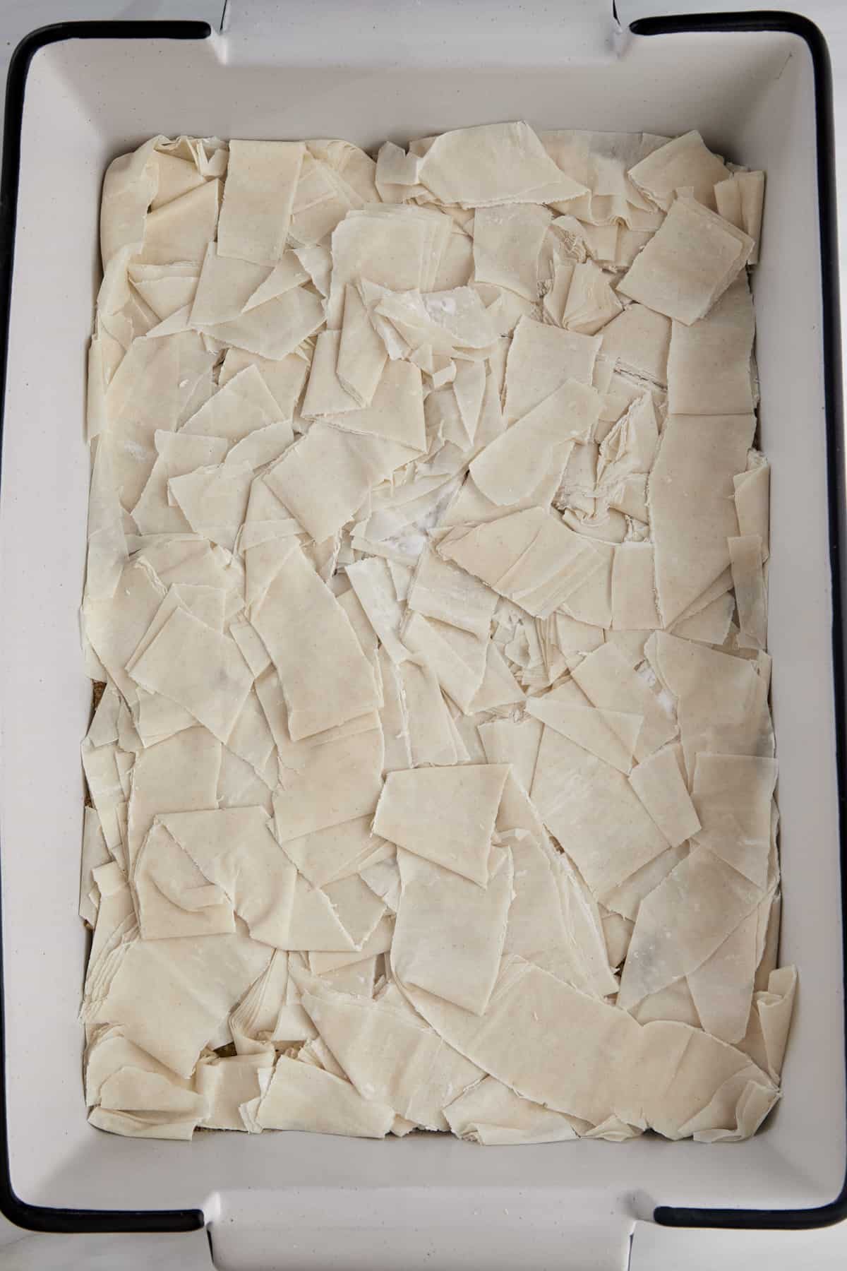Easy baklava recipe ingredients being layered.