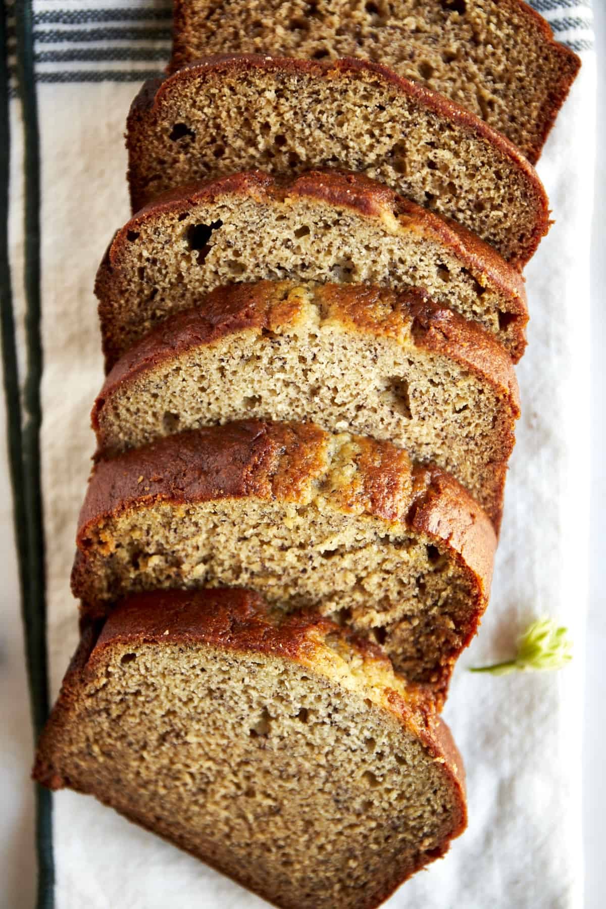 A loaf of blender banana bread sliced into pieces.