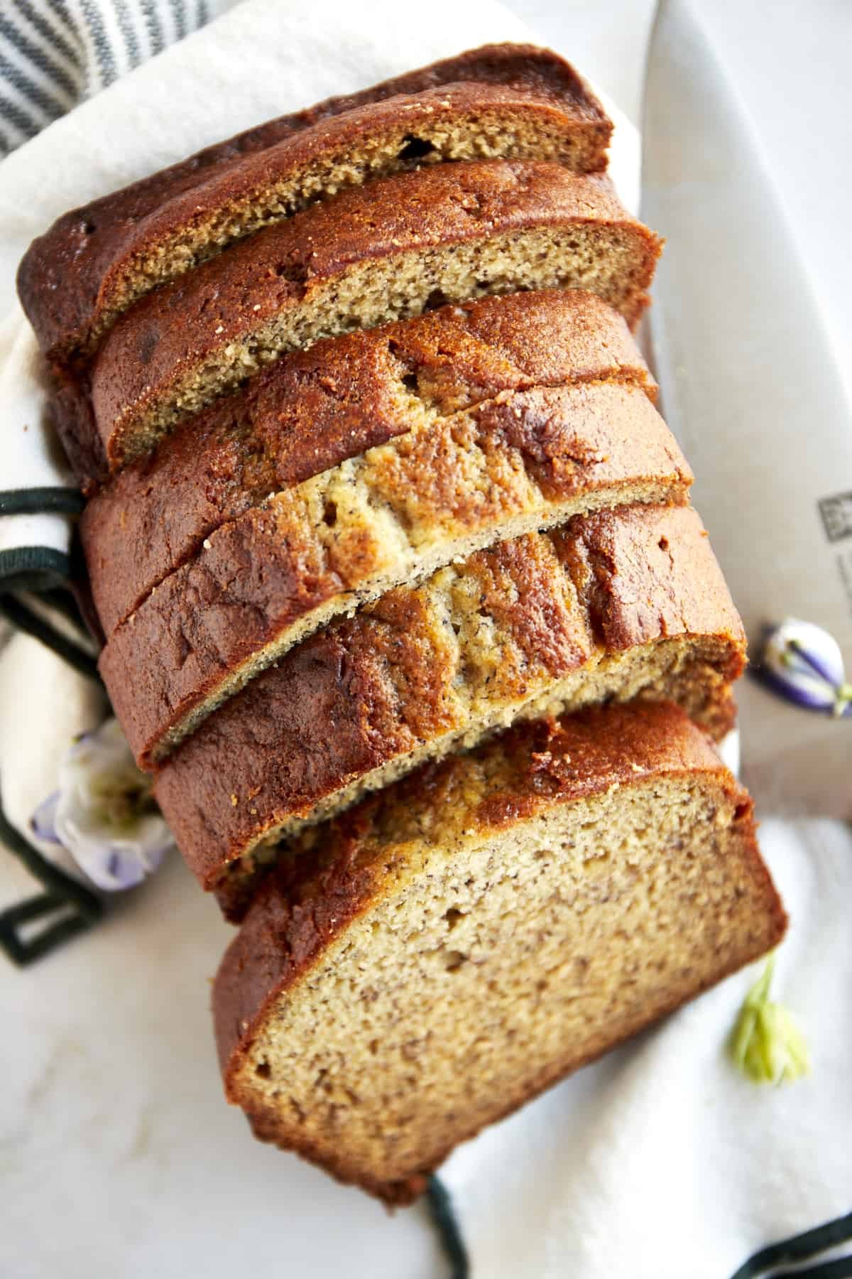 A loaf of blender banana bread sliced into pieces.