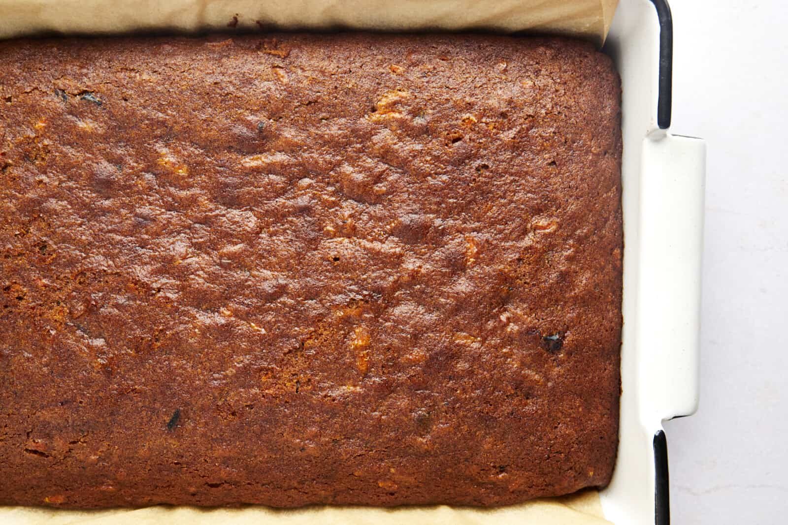 Overhead image of baked carrot cake in a baking pan.
