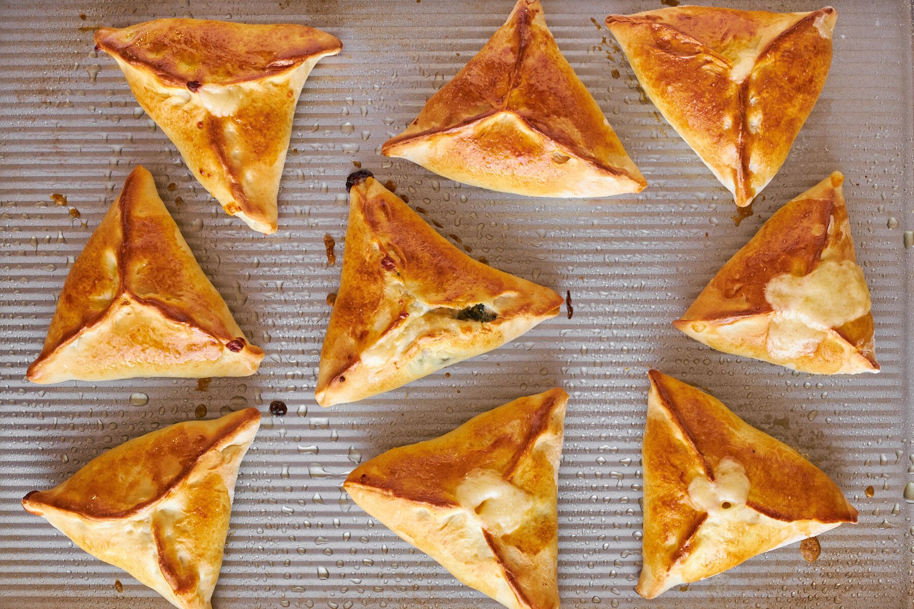 Baked fatayer on a baking sheet.