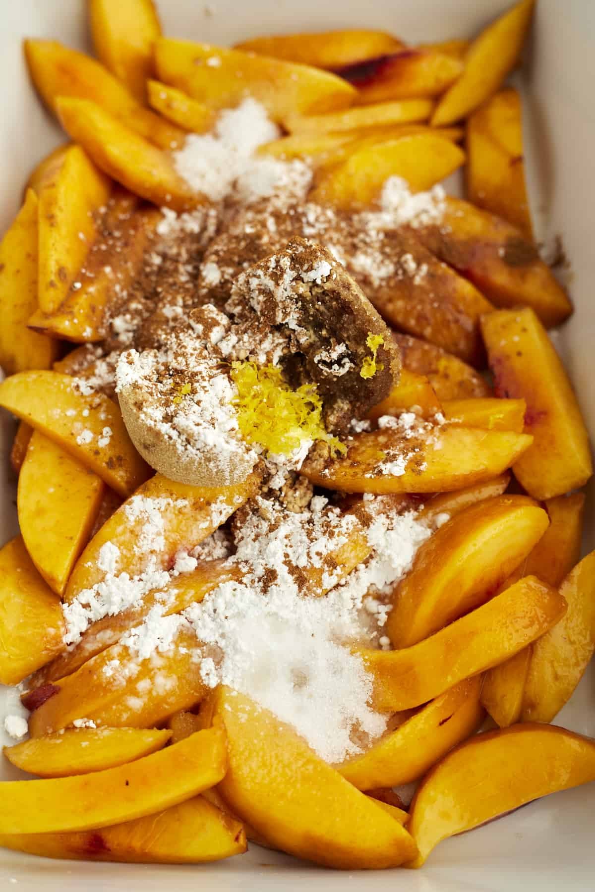 overhead image of peaches topped with cinnamon and sugar.