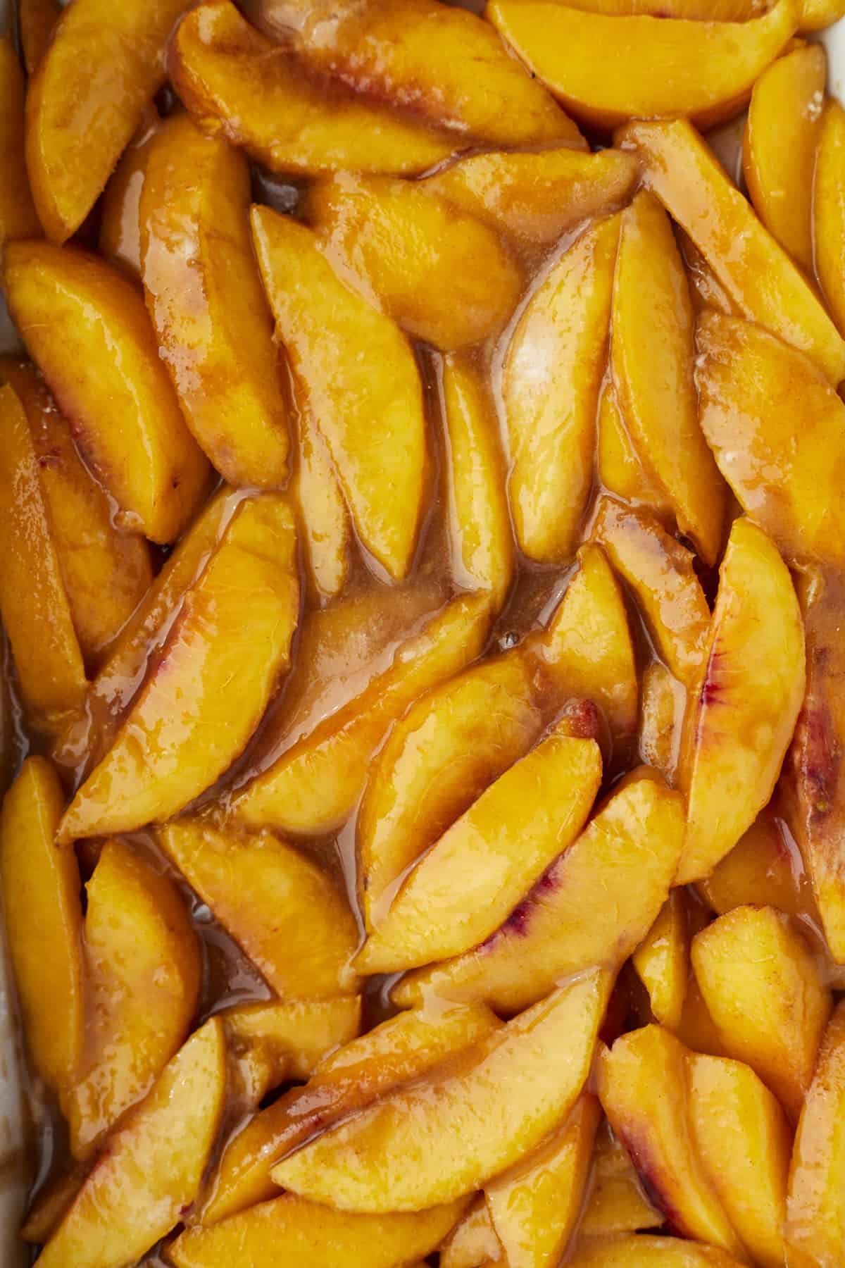 close up image of sugar and cinnamon coated peaches.