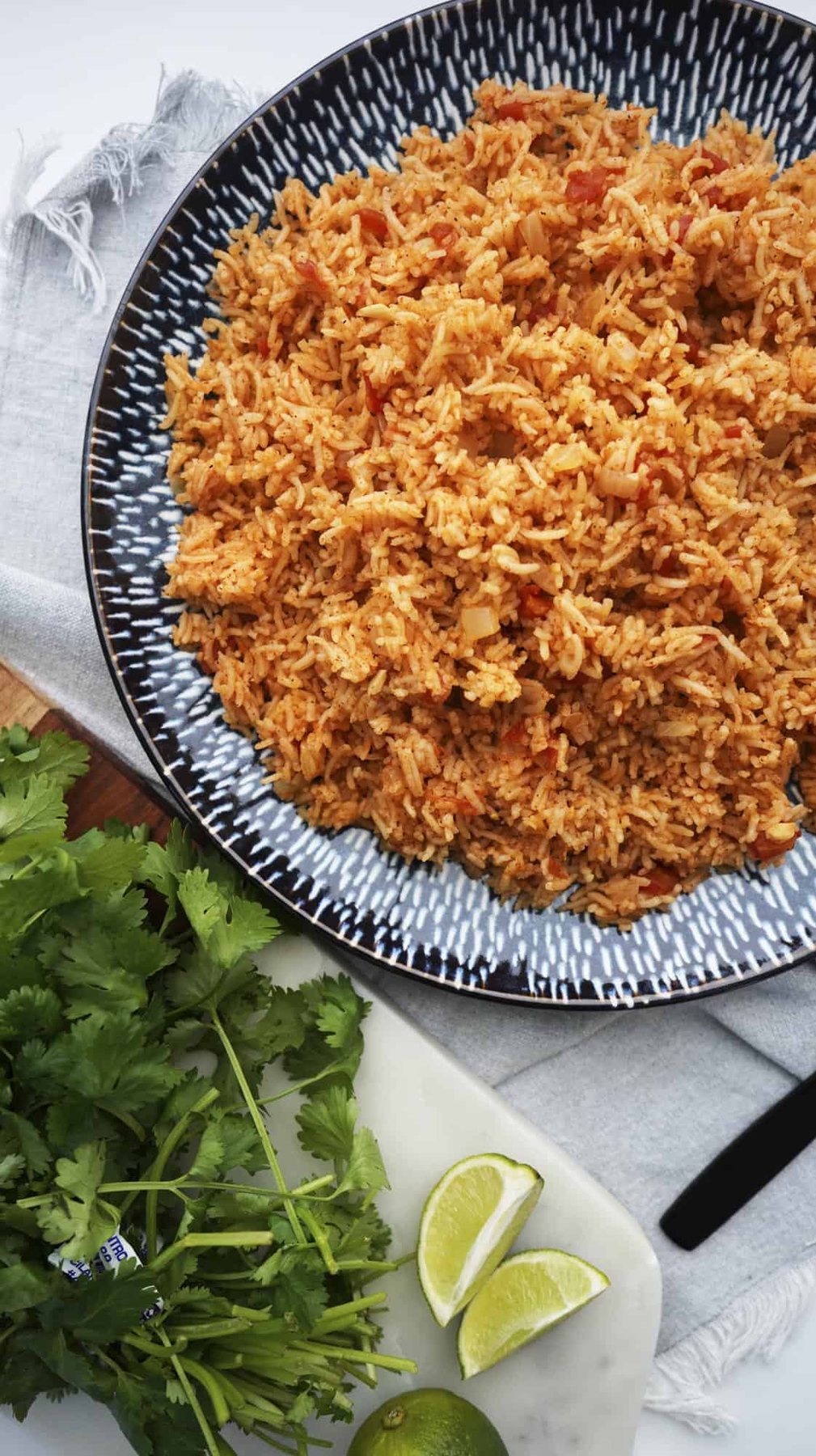overhead of spanish rice with fresh lime and cilantro