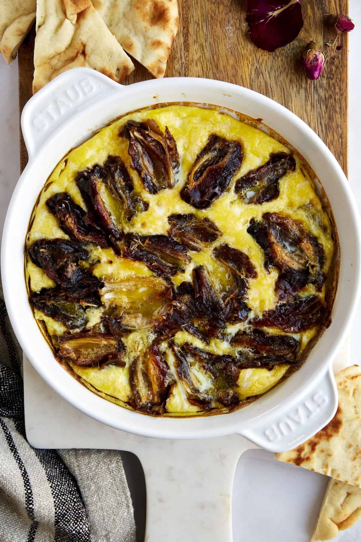 Eggs and dates in a round baking dish.