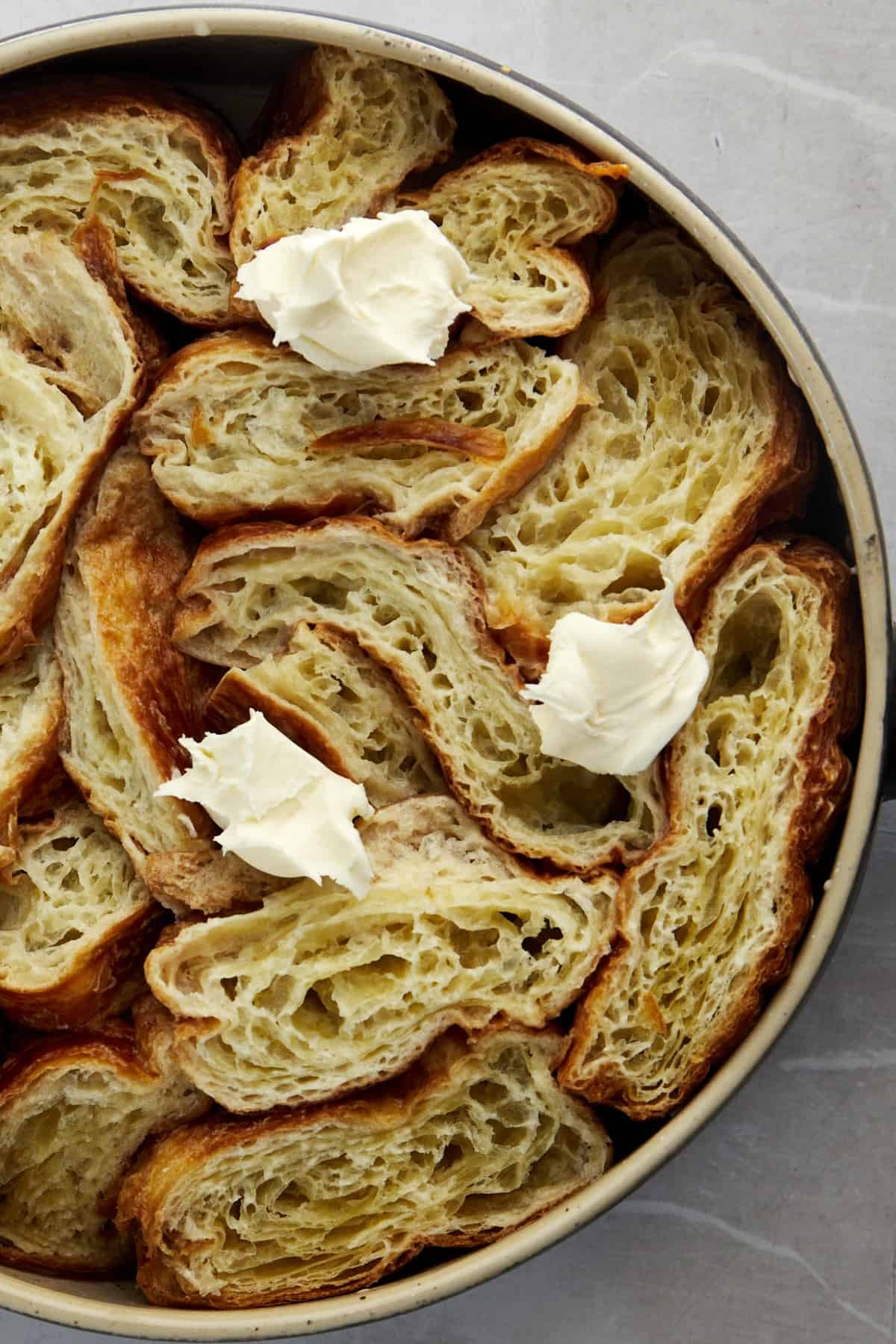 unbaked yawmiyat om ali topped with clotted cream