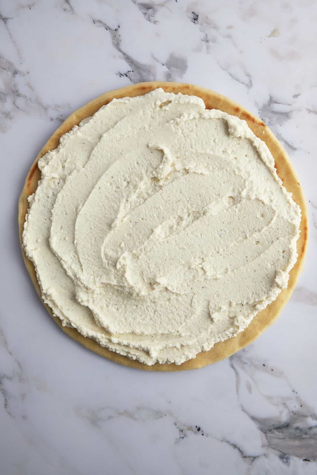 Pizza crust topped with whipped feta.