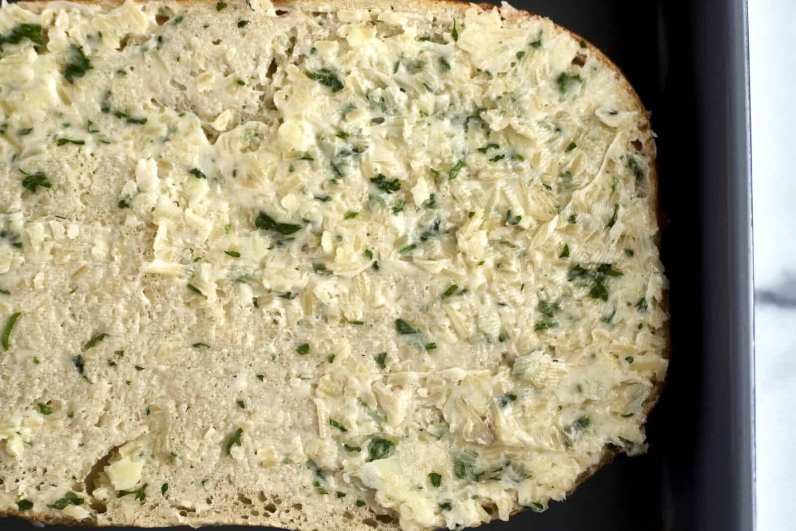 unbaked bread topped with garlic butter
