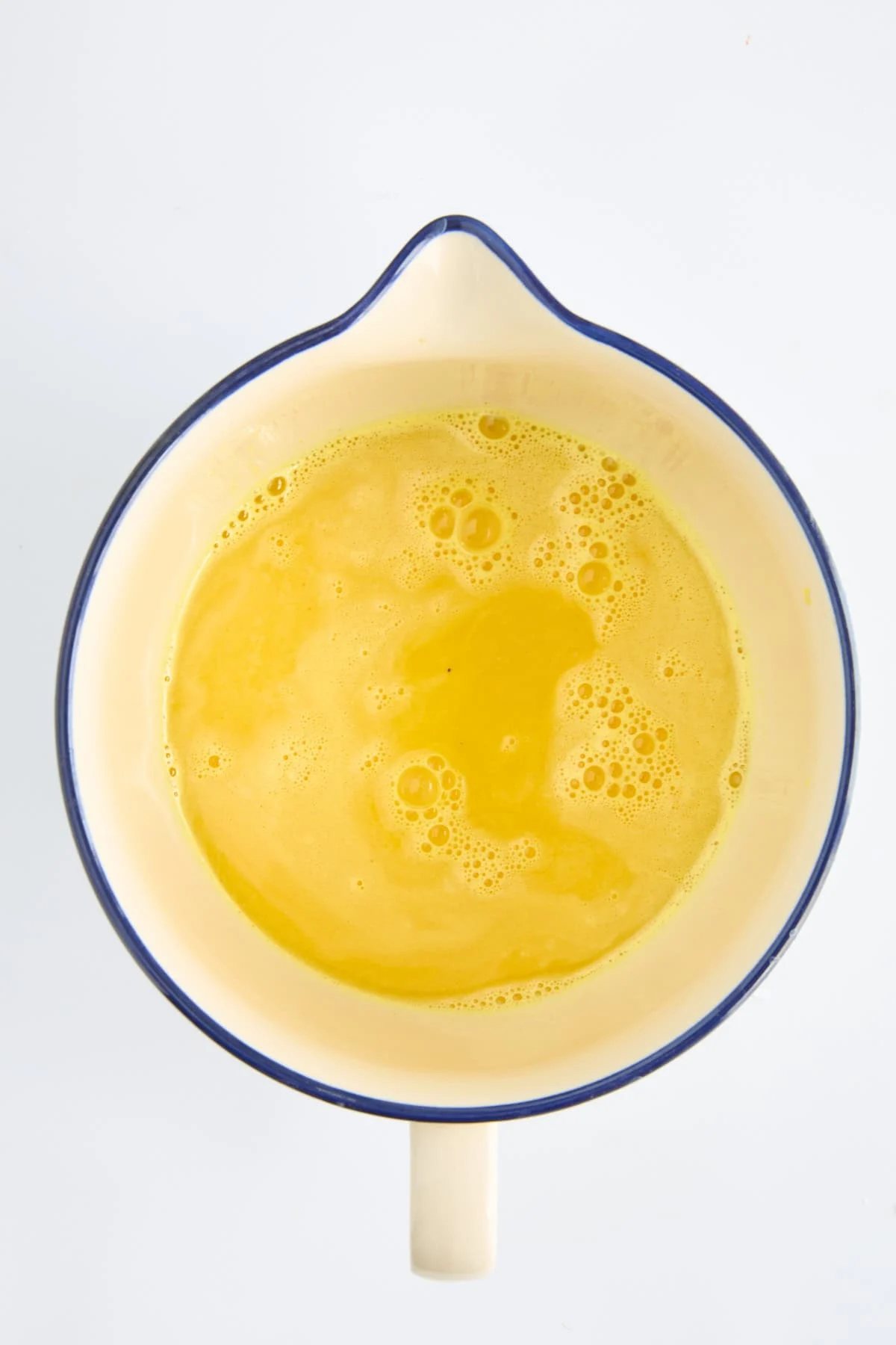 A bowl of ginger turmeric shot liquid.