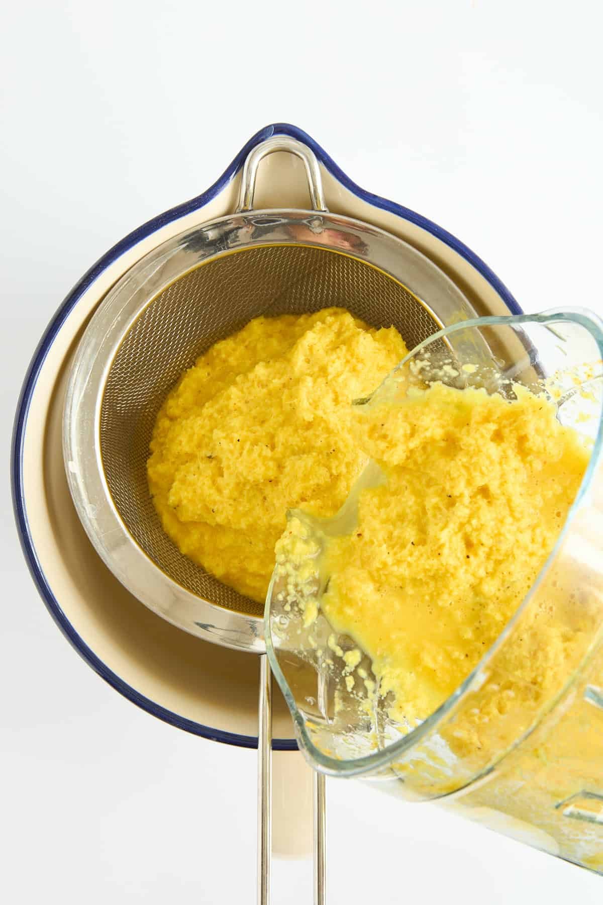 Turmeric shots being drained in a fine mesh sieve.