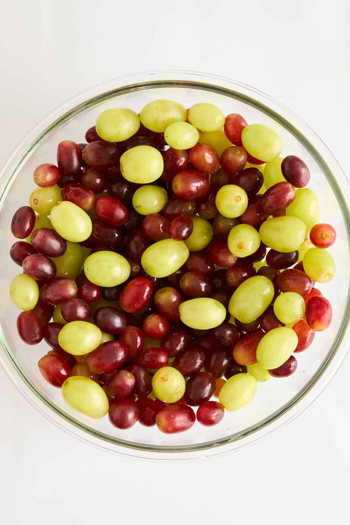Red and green grapes in a large bowl.
