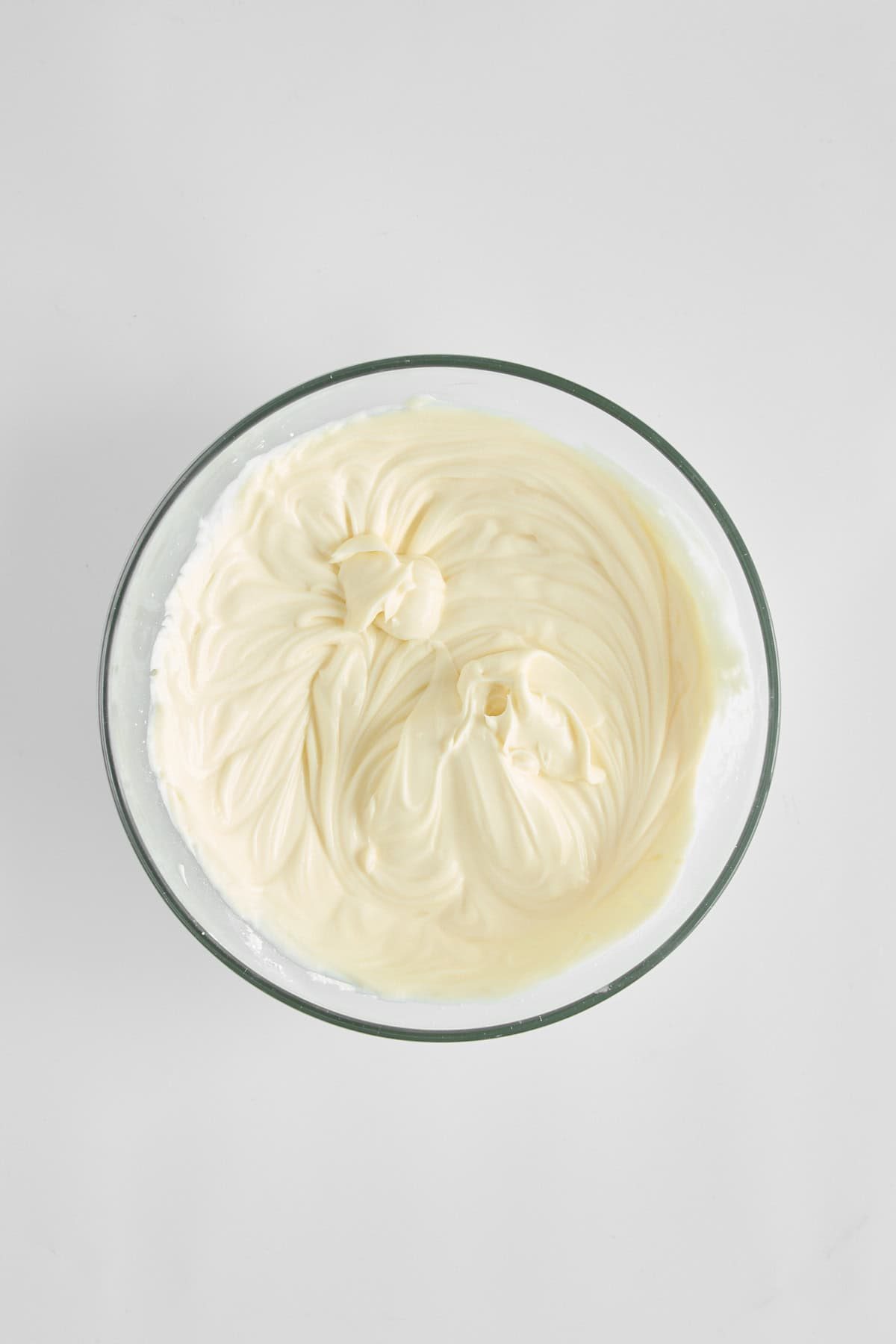 Whipped powdered sugar, mascarpone, and Greek yogurt in a bowl.