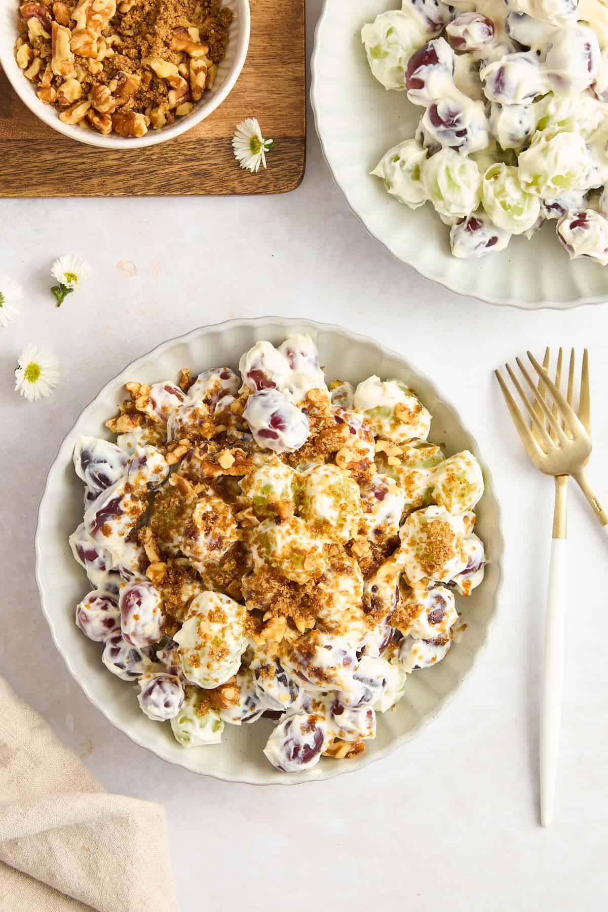 A bowl of Mediterranean-inspired grape salad with a walnut topping.
