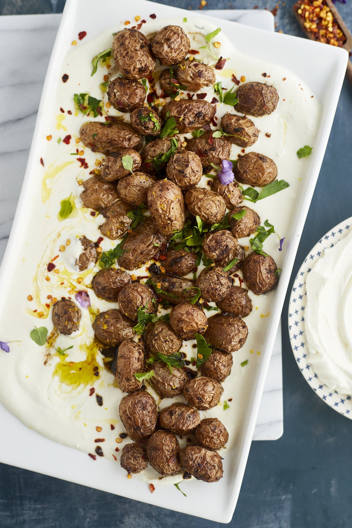 Greek potatoes on top of whipped feat dip