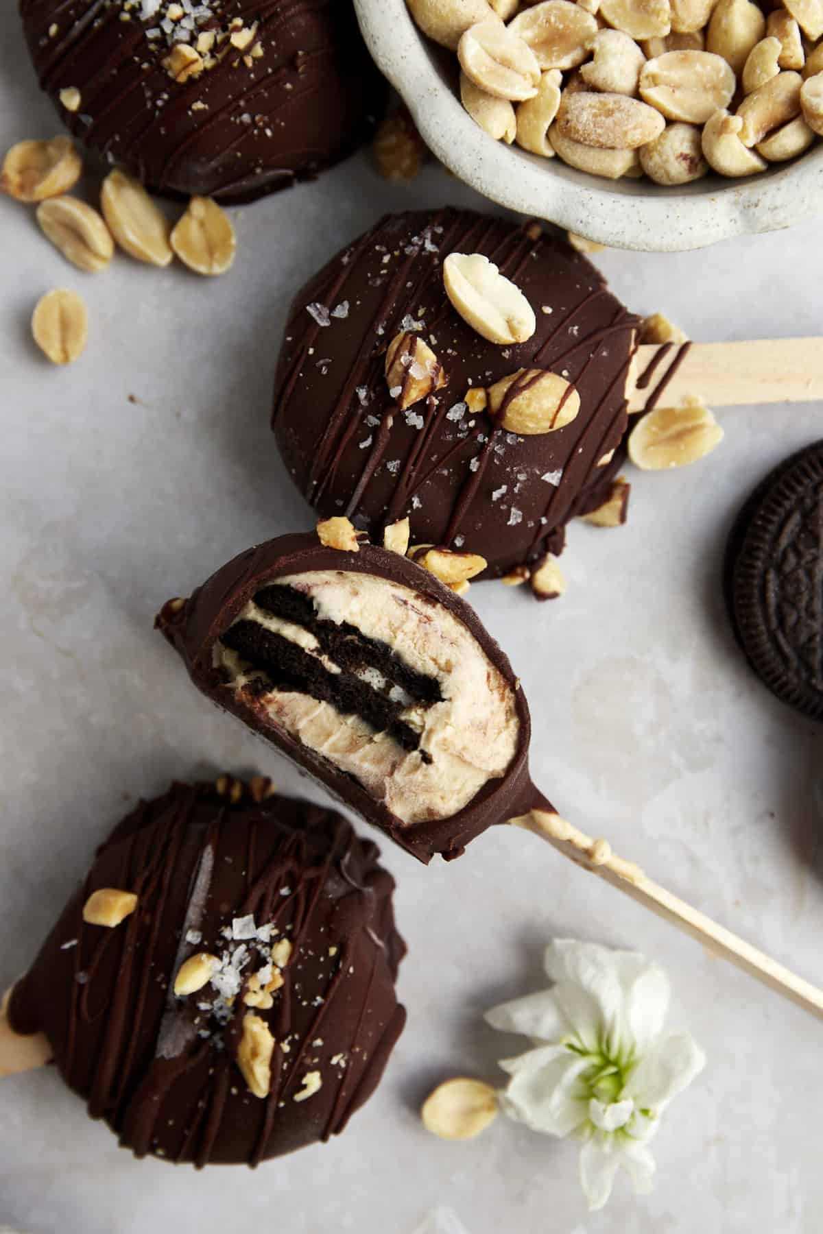 Peanut butter Oreo yogurt popsicles topped with sea salt and peanuts.