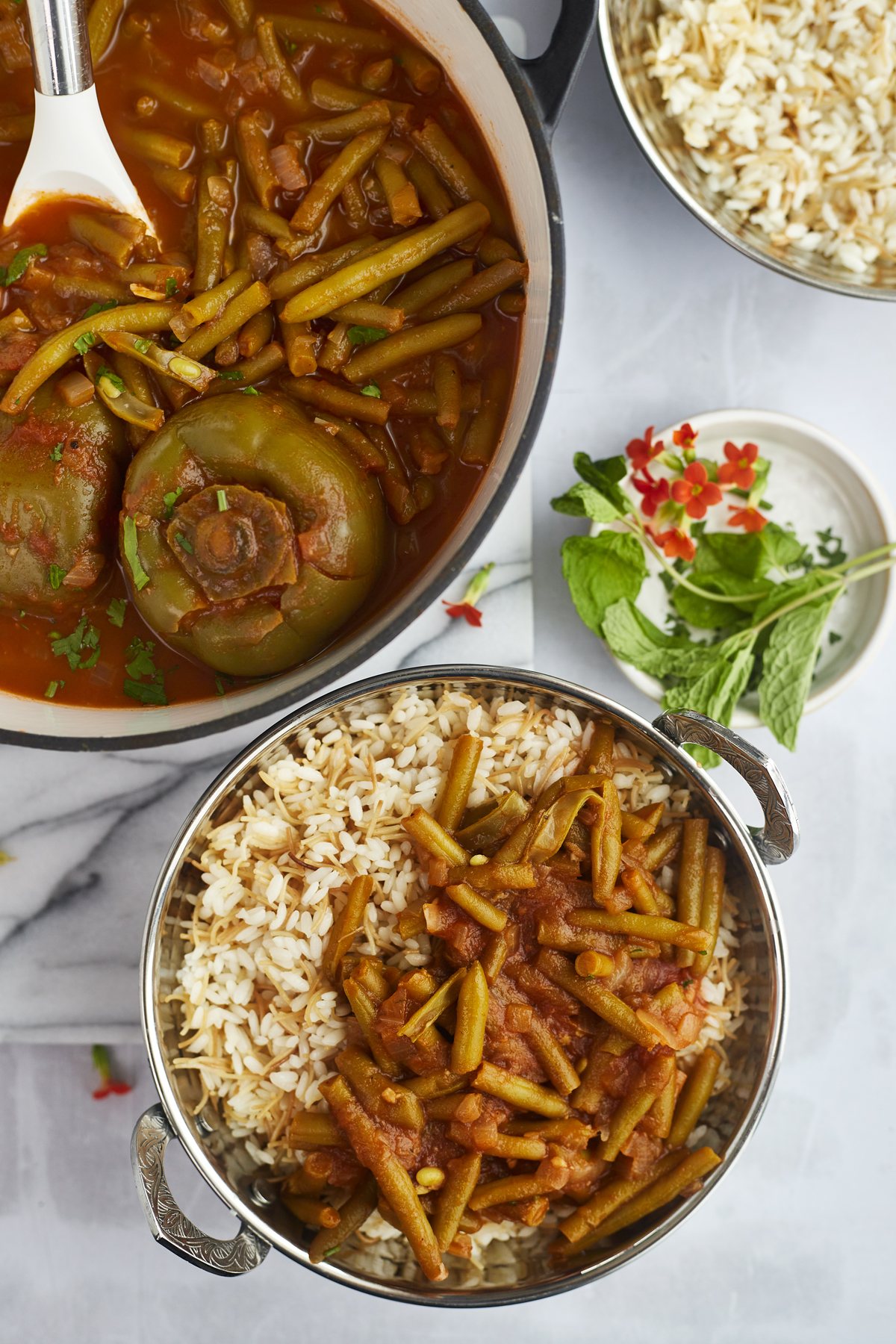 a pot of fasooliya and a side of green bean stew over rice