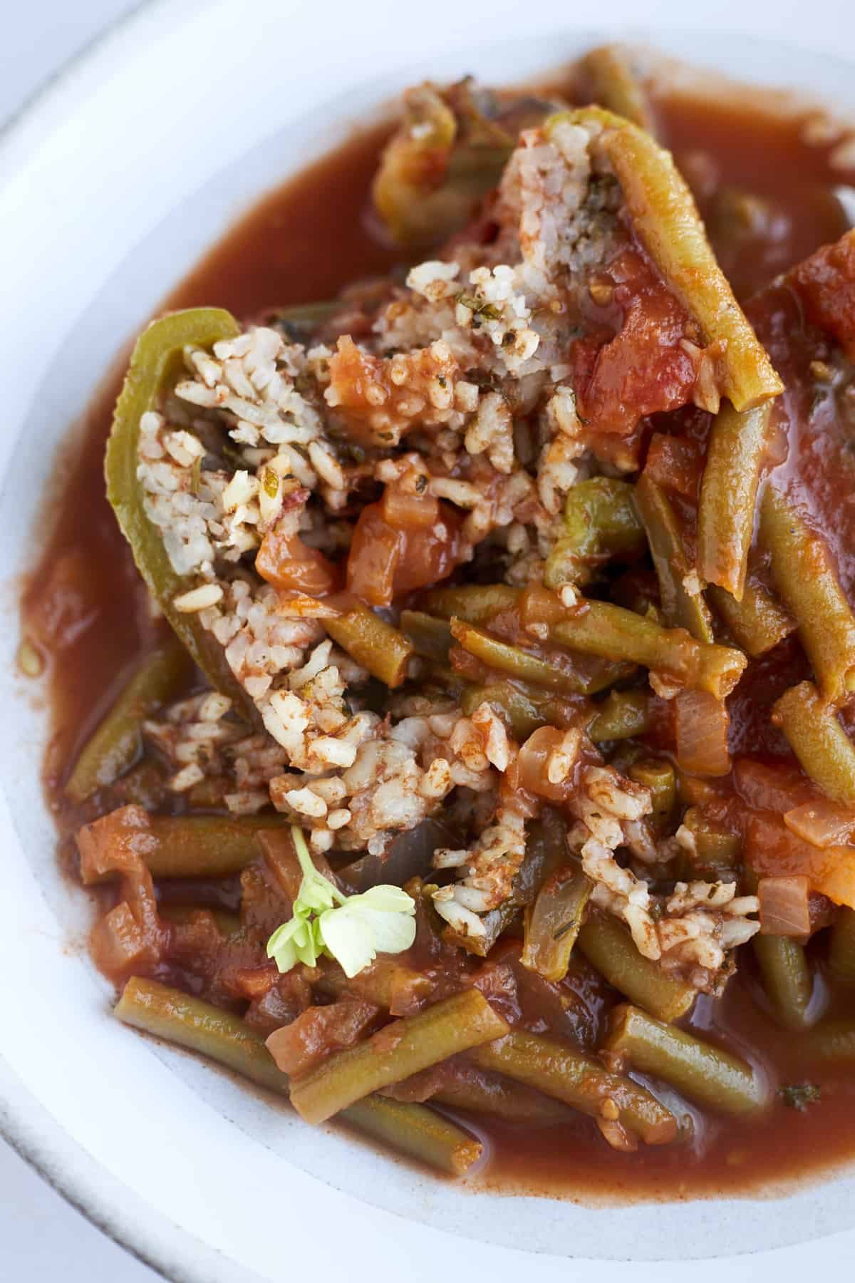 a picture of half a stuffed pepper with green bean stew