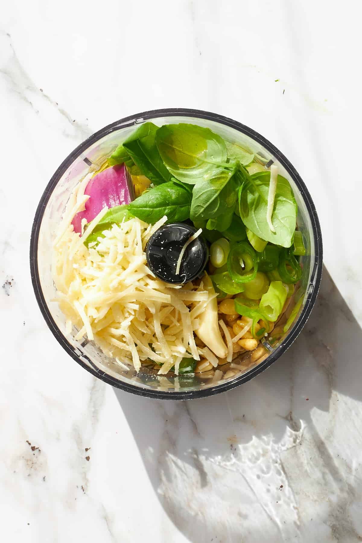 Ingredients for green goddess dressing in a food processor.