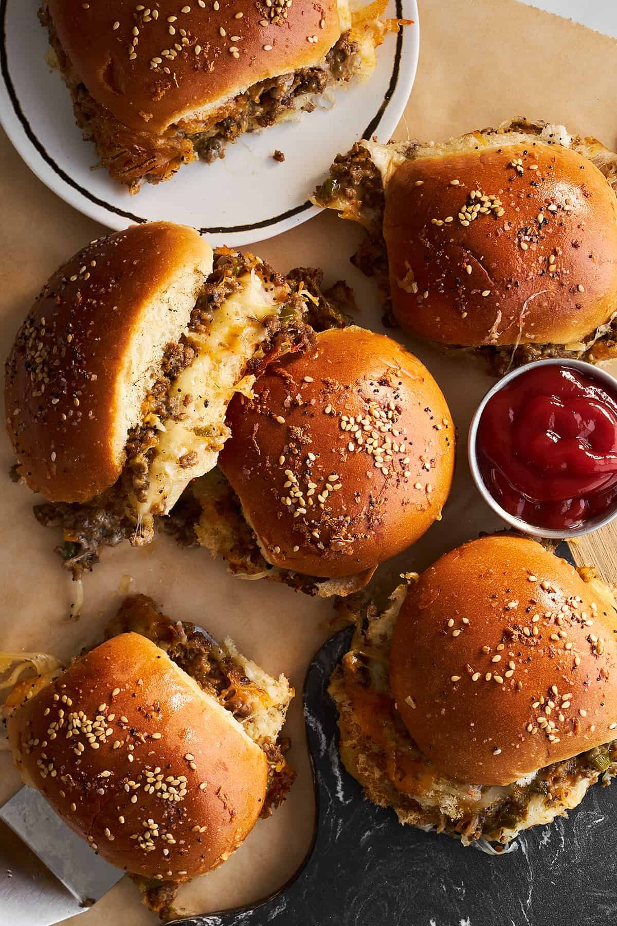 Cheese ground beef sliders with a side of ketchup.