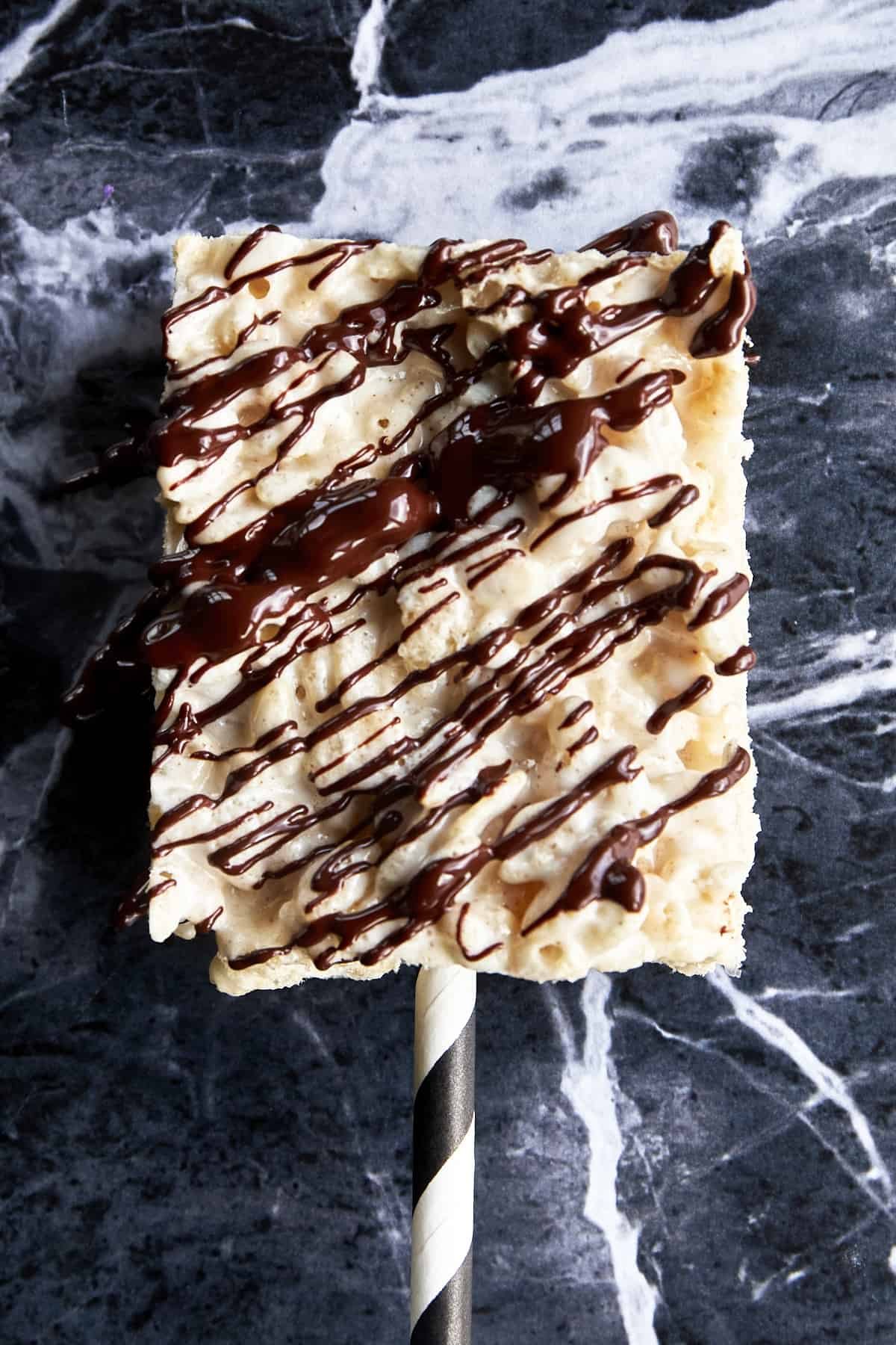 Chocolate drizzled over a rice krispie treat.
