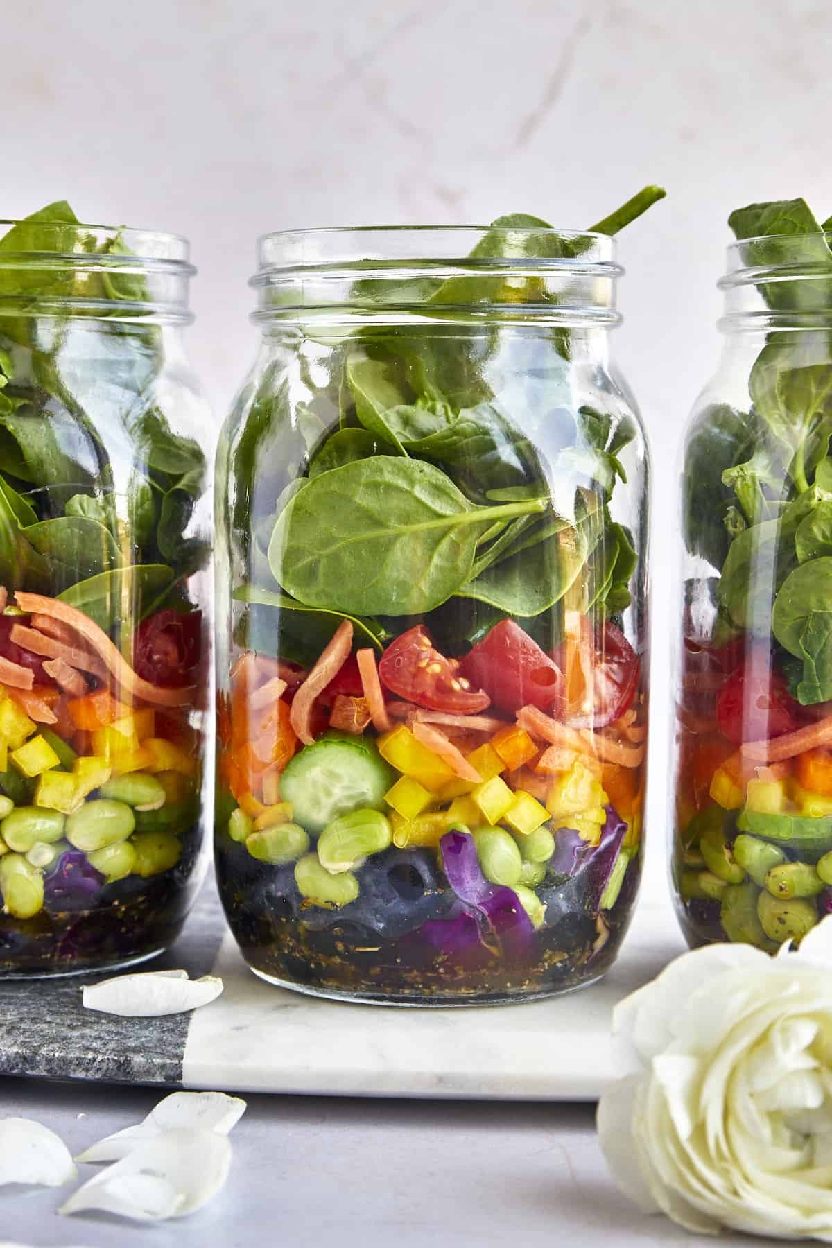 Three mason jars full of rainbow salad.