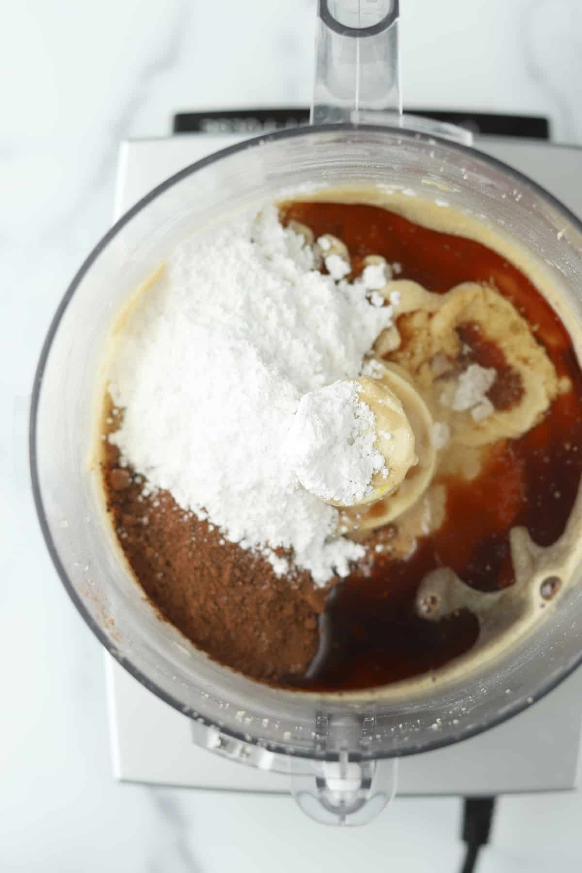 melted chocolate chips, brewed espresso, powdered sugar, vanilla extract, cocoa powder, and water over hazelnut butter in a food processor