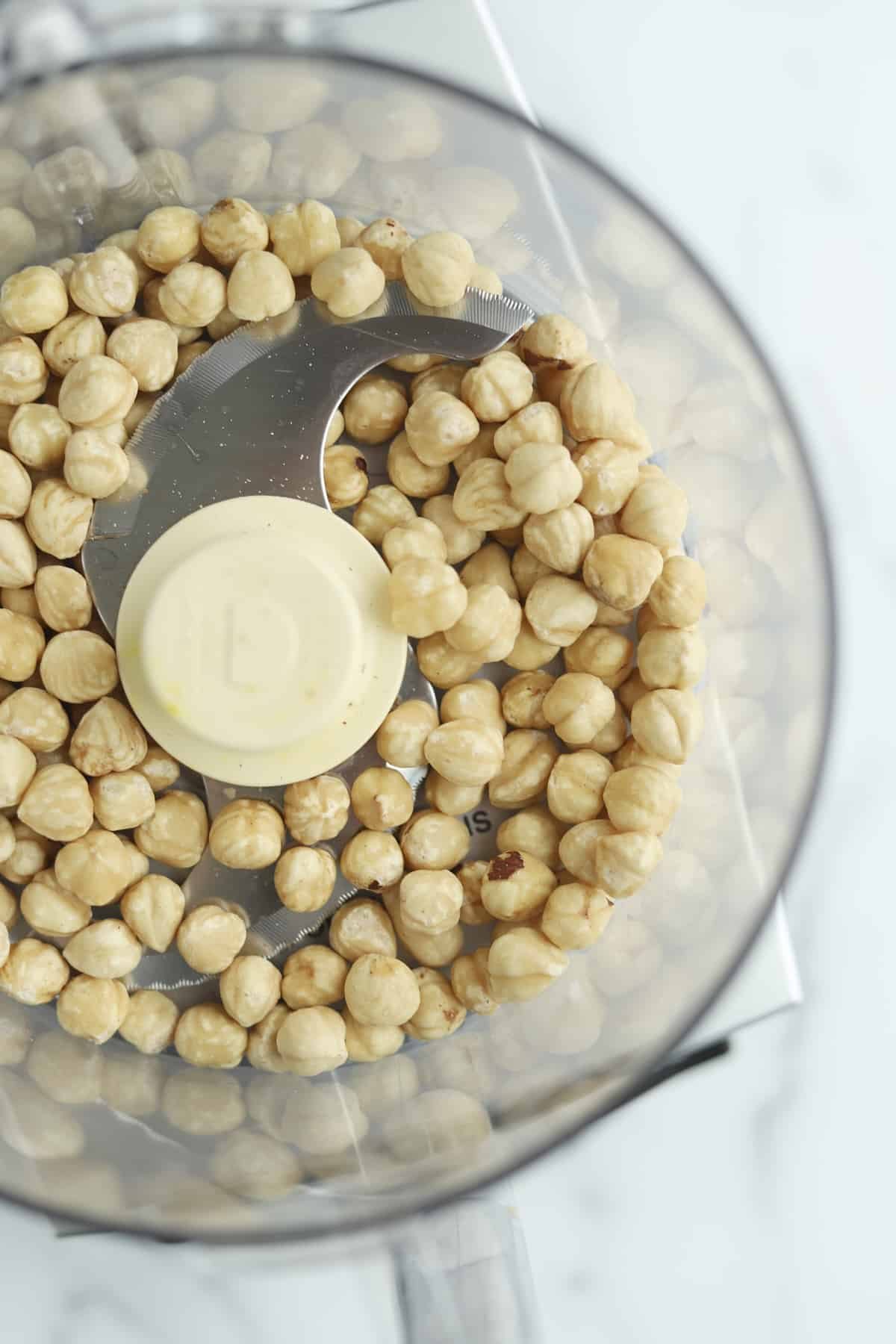overhead image of hazelnuts in a food processor